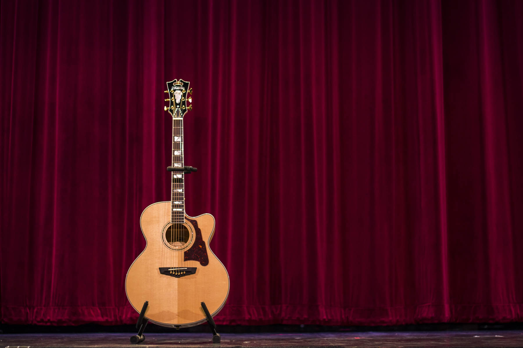 Acoustic guitar on stage.