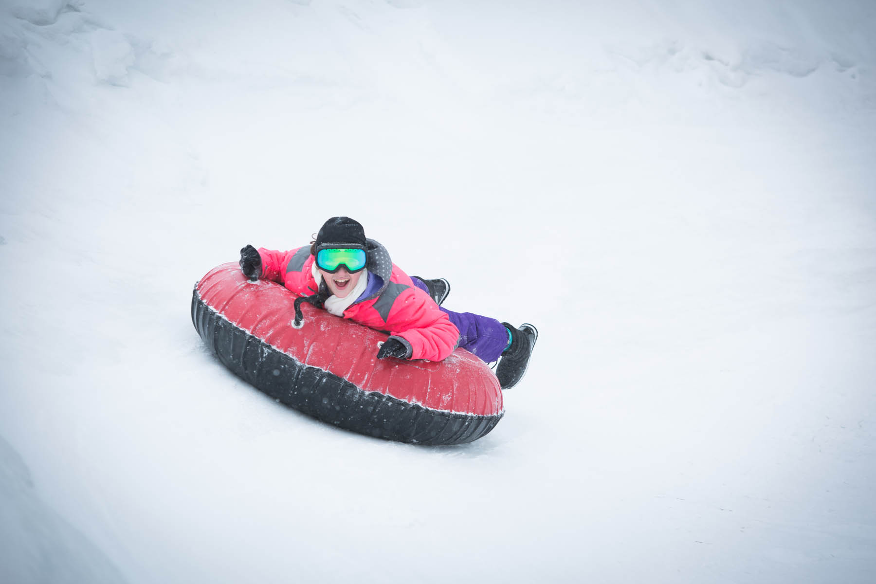 Young person on a snow tube.