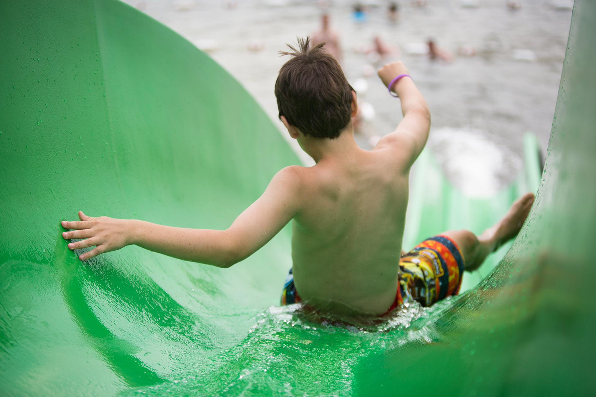 Boy going down a water slide.