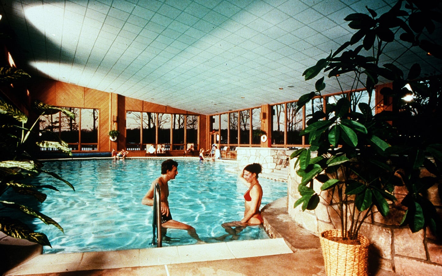 Man and woman standing in the indoor pool