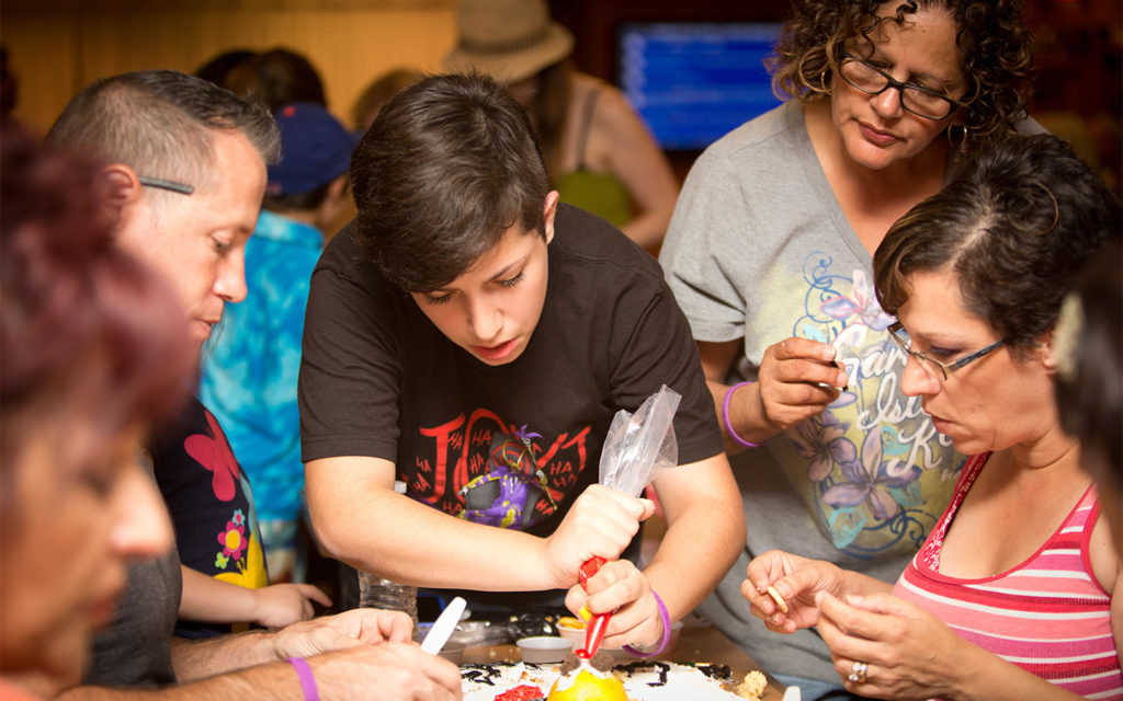 Group decorating a cake.