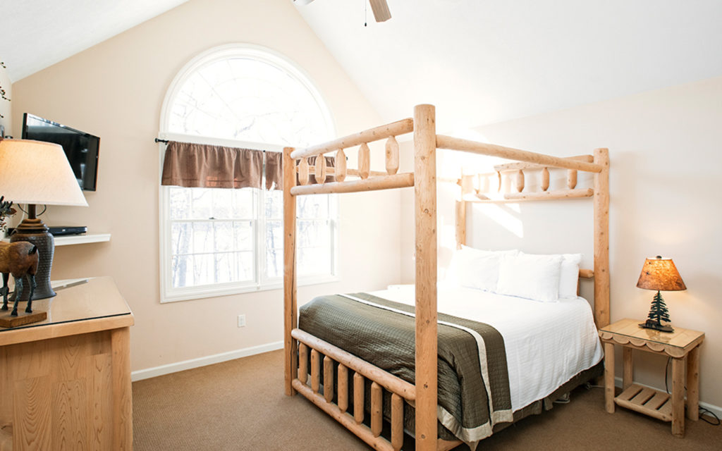 Lake Estate bedroom with four post log bed.