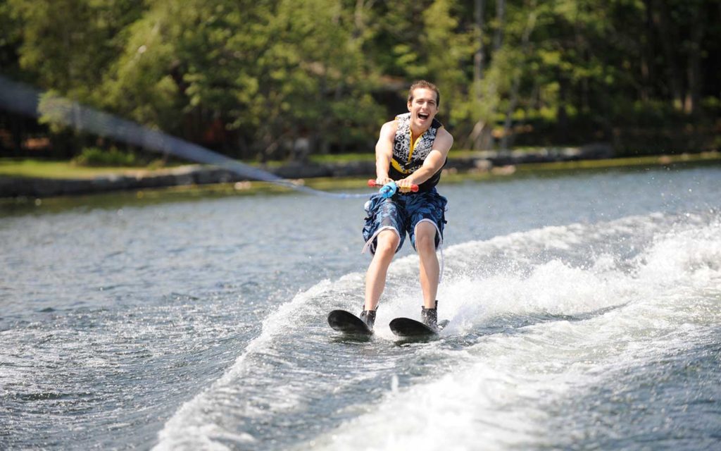 Person waterskiing and smiling.