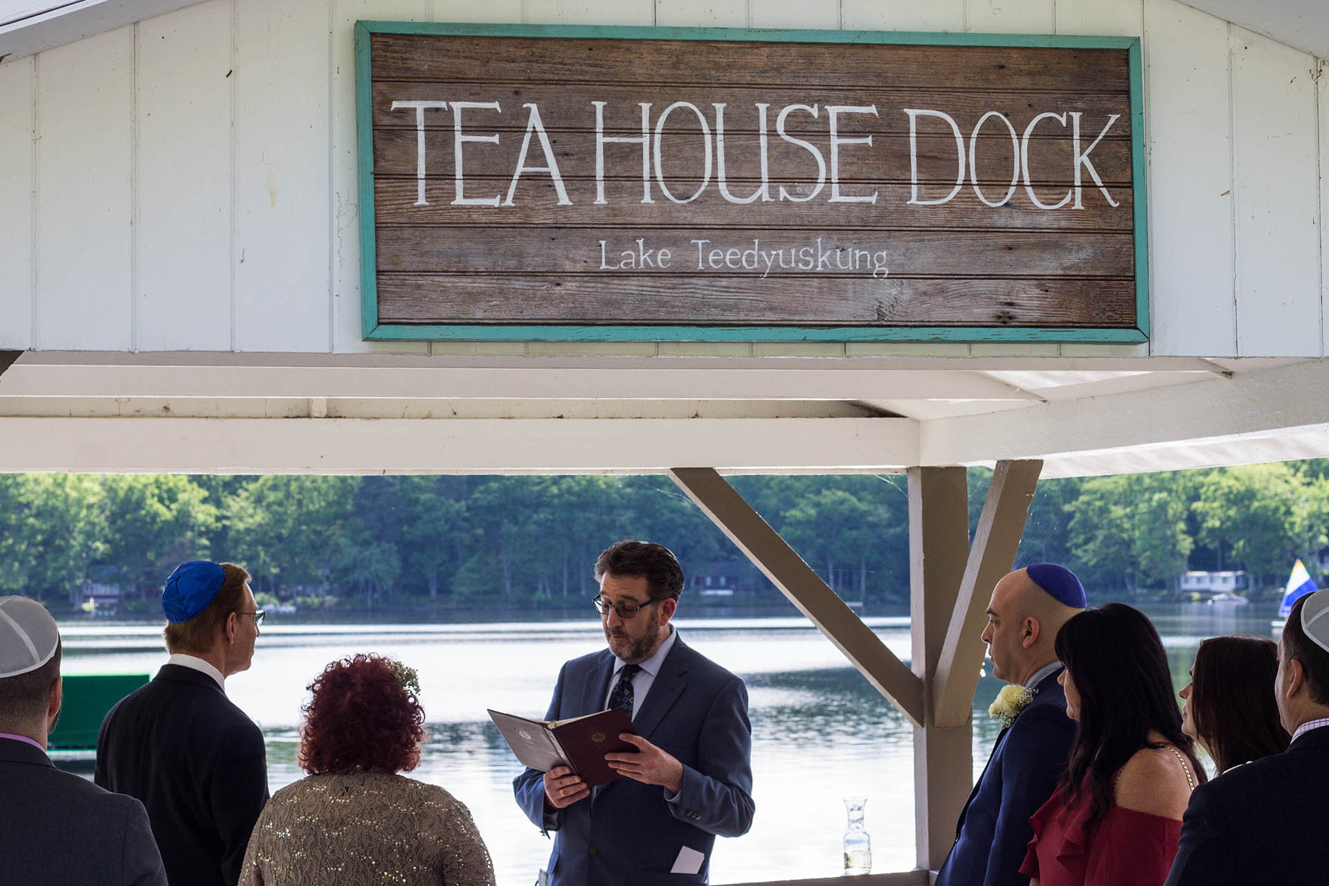 Rabbi speaking at Tea House Dock during vow renewal.