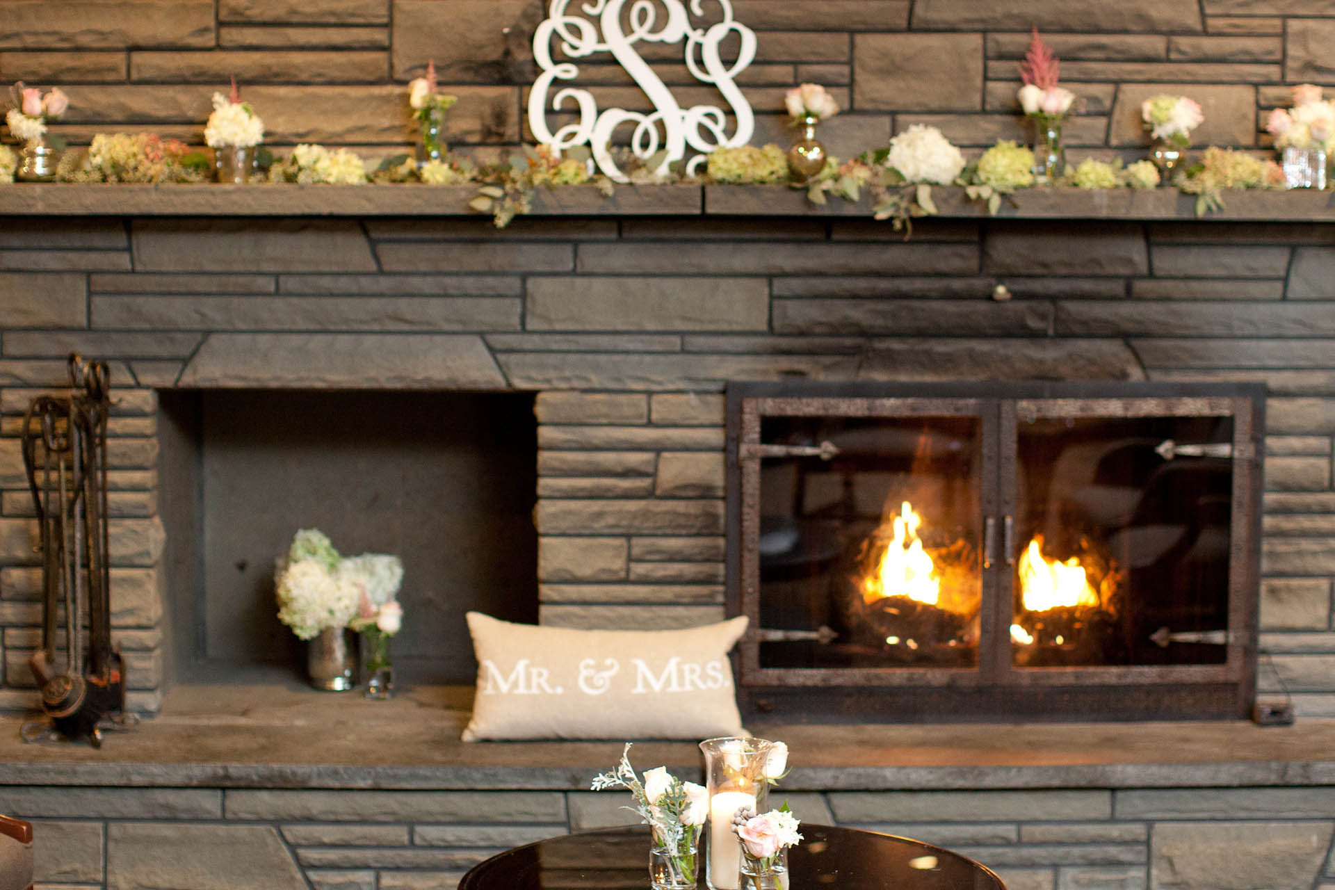 Wedding reception fireplace with decorative garlands.