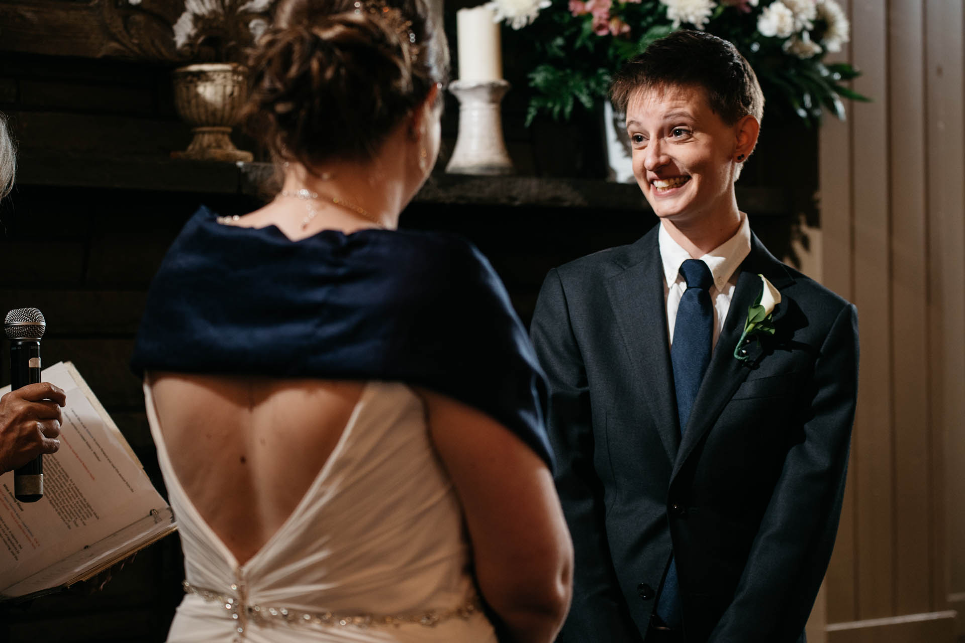 LGBT wedding couple smiling at one another.