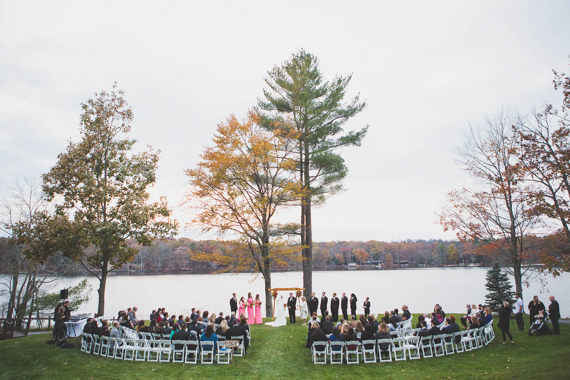 Long shot of lakeside wedding ceremony.