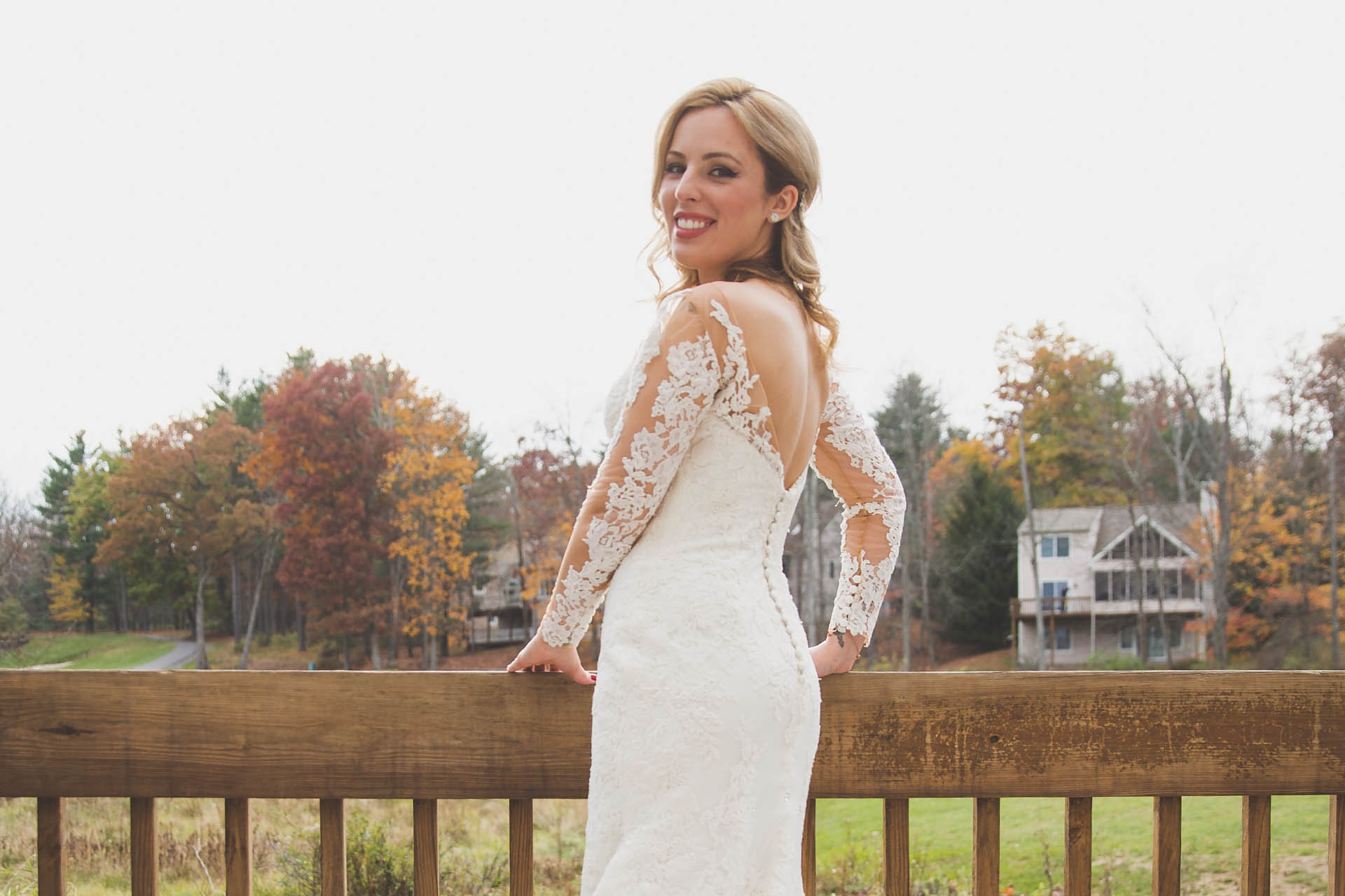 Bride smiling and overlooking Woodloch Resort's grounds.