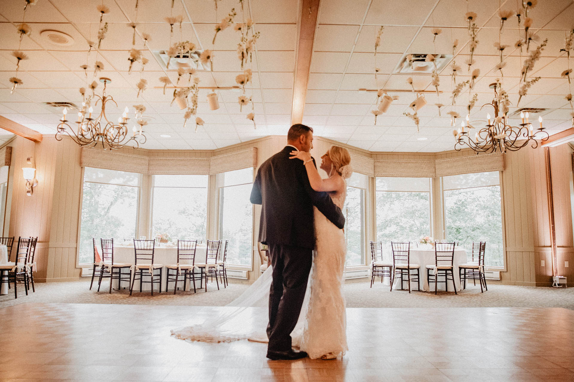 Bride and Groom dancing in empty reception hall.