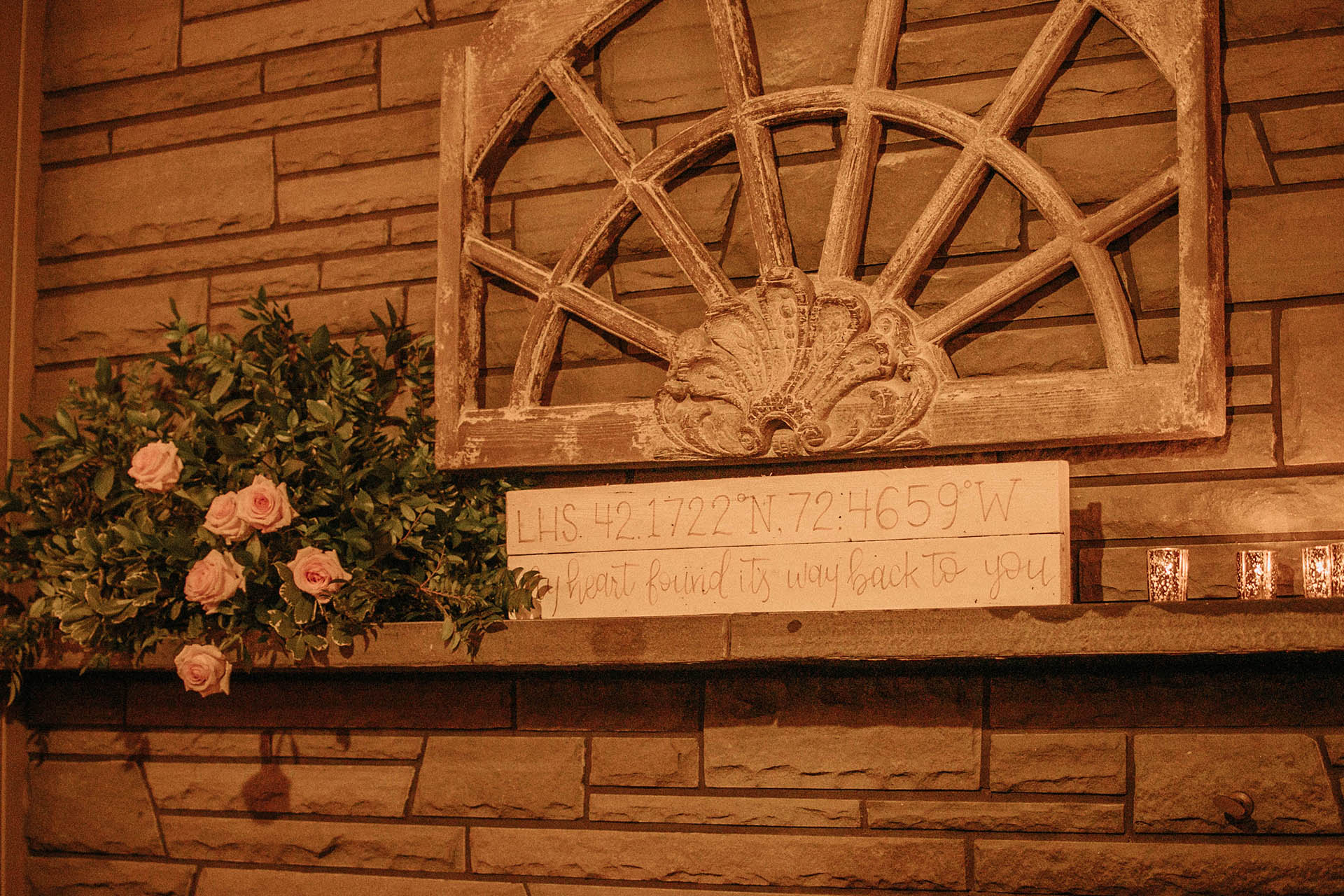 Mantle with flowers, candle and wooden text. Text: my heart found it's way back to you.