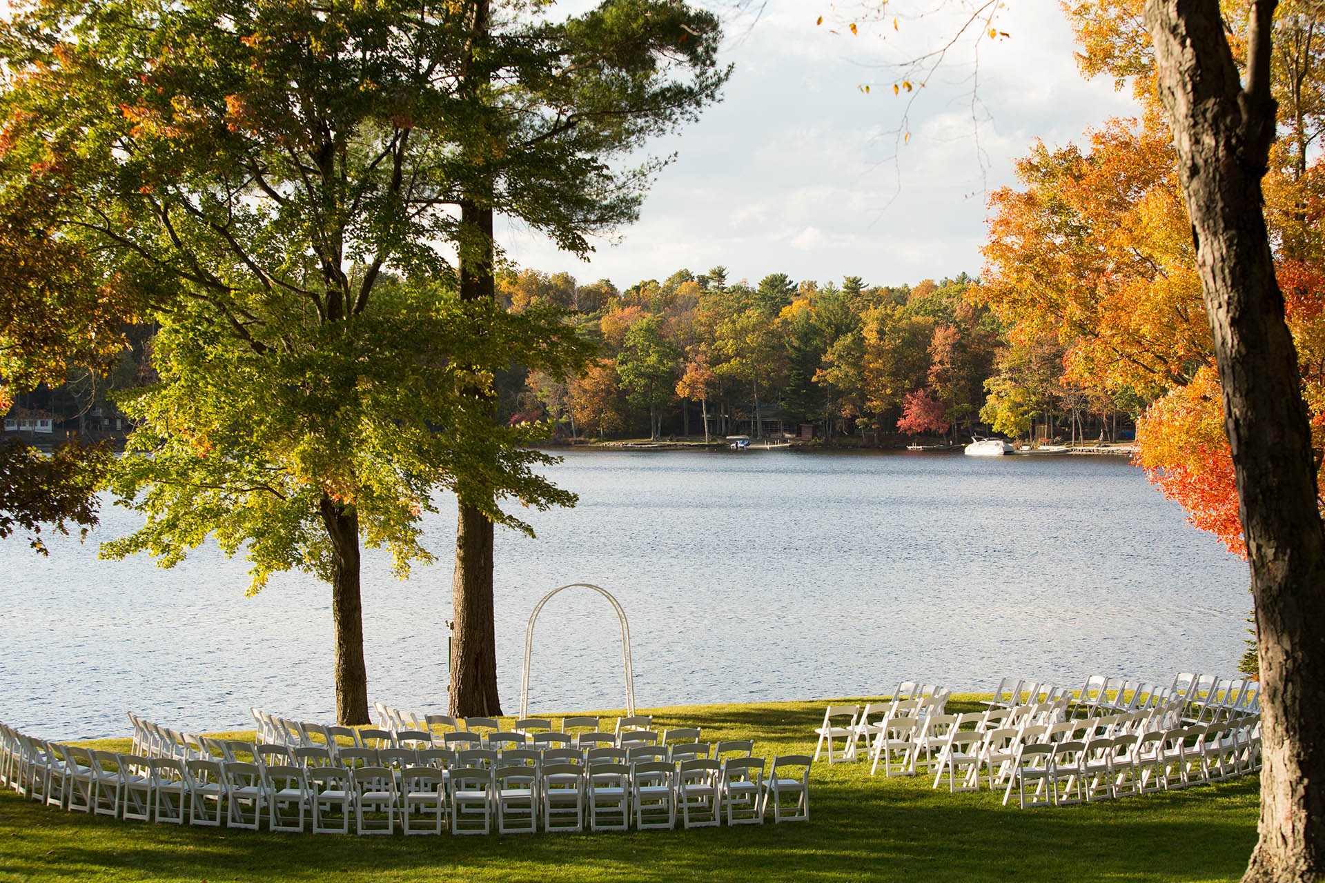 Lakeshore wedding ceremony setup with circular seating setup.