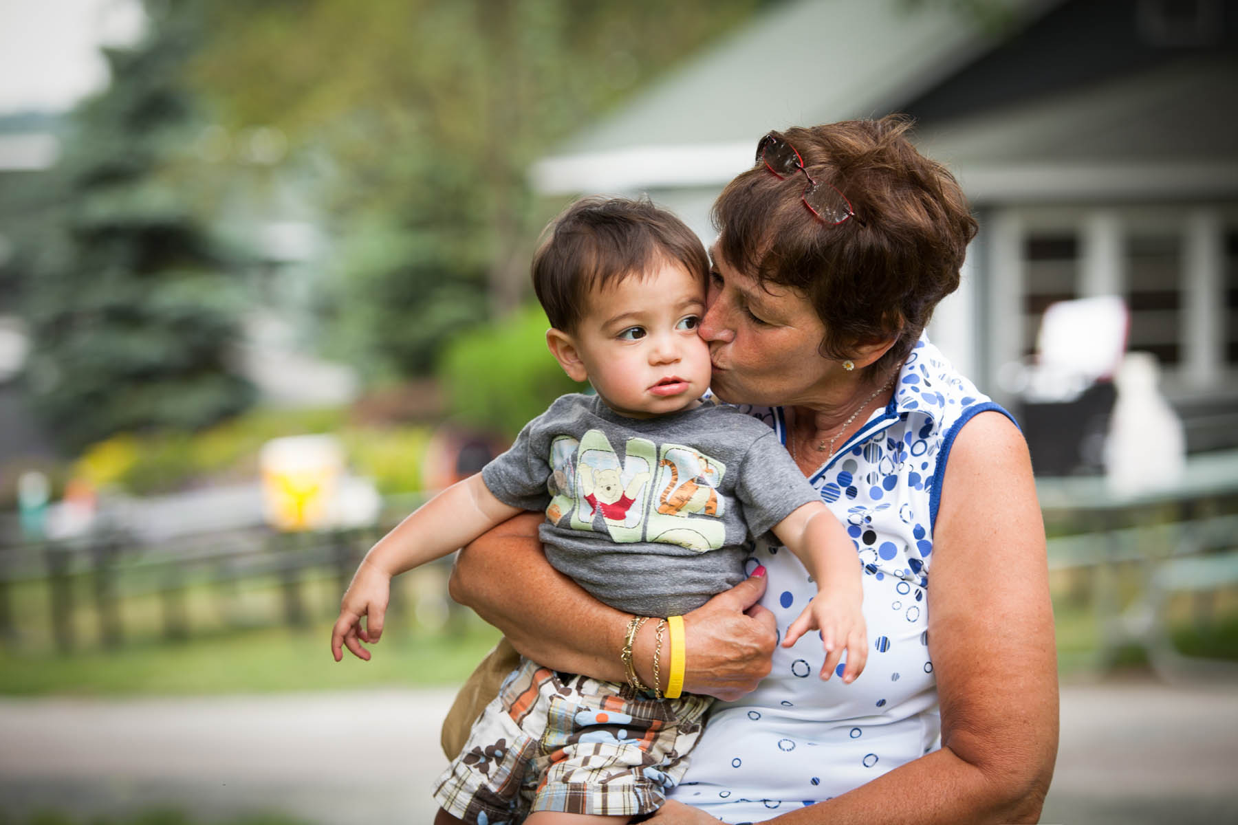 Adult woman kissing toddler on the cheek.