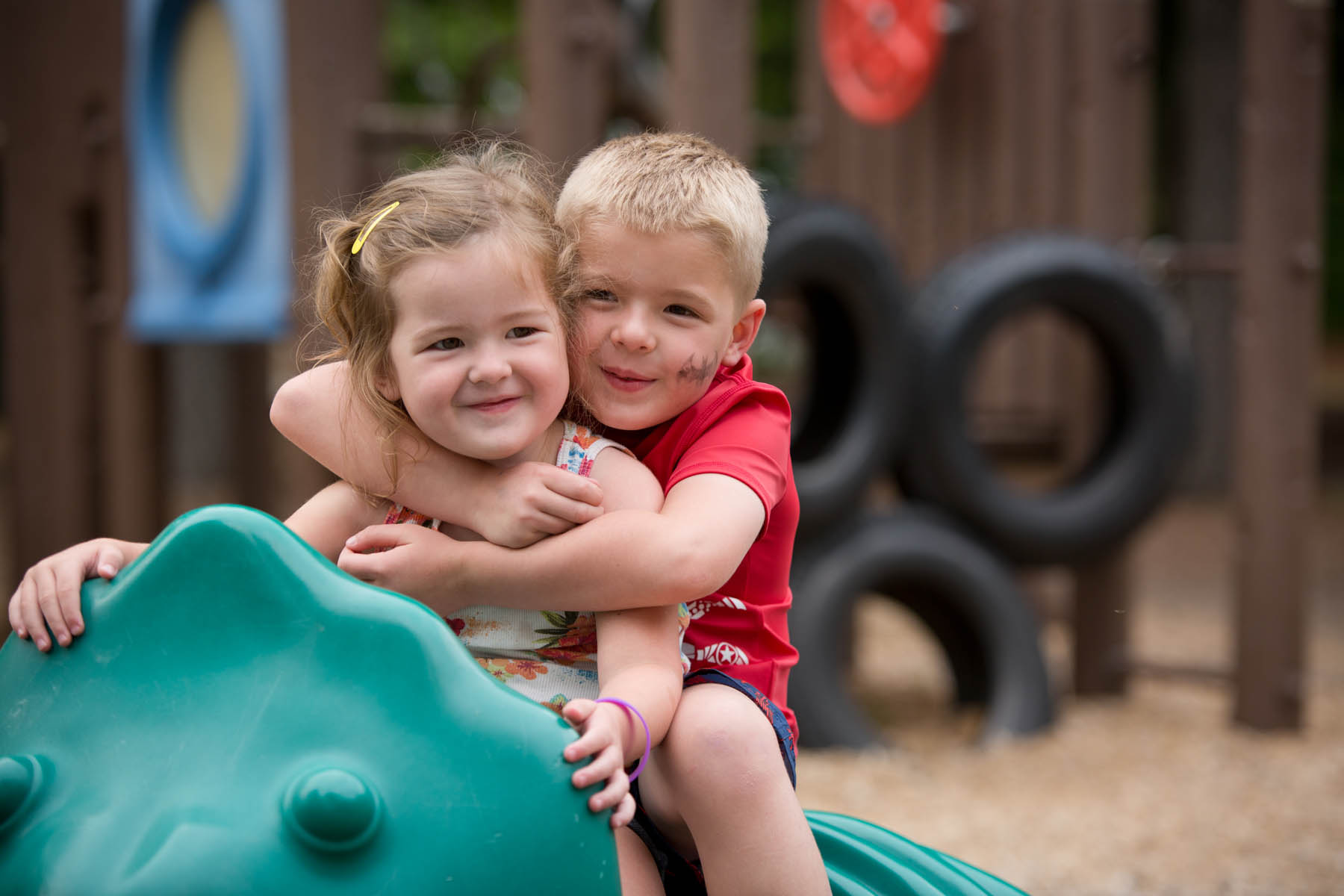 Young boy and girl hugging.