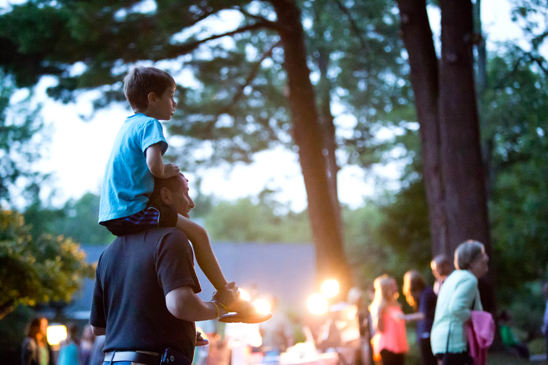 Young boy on dad's shoulders.