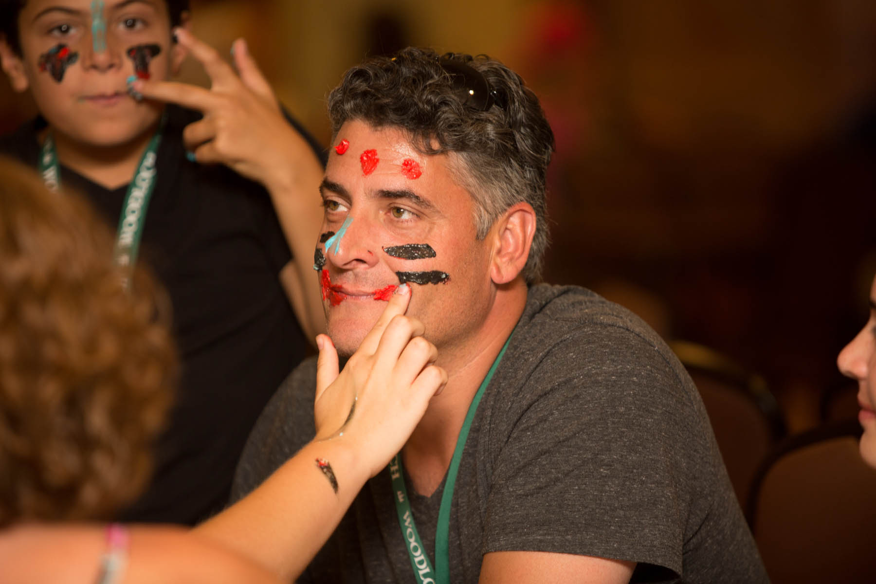 Man getting face painted with frosting.