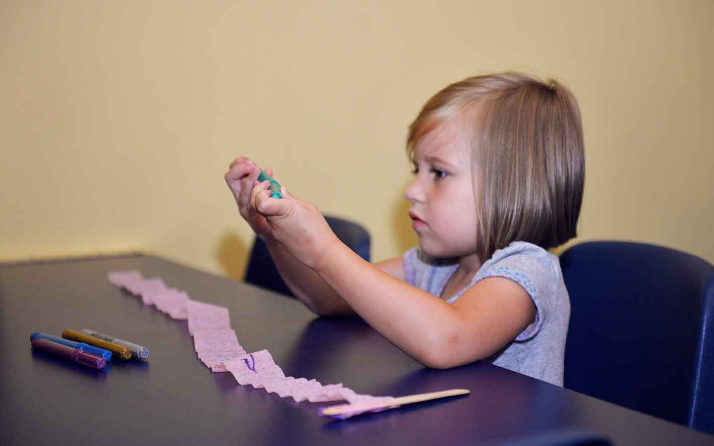 Young girl playing with clay.