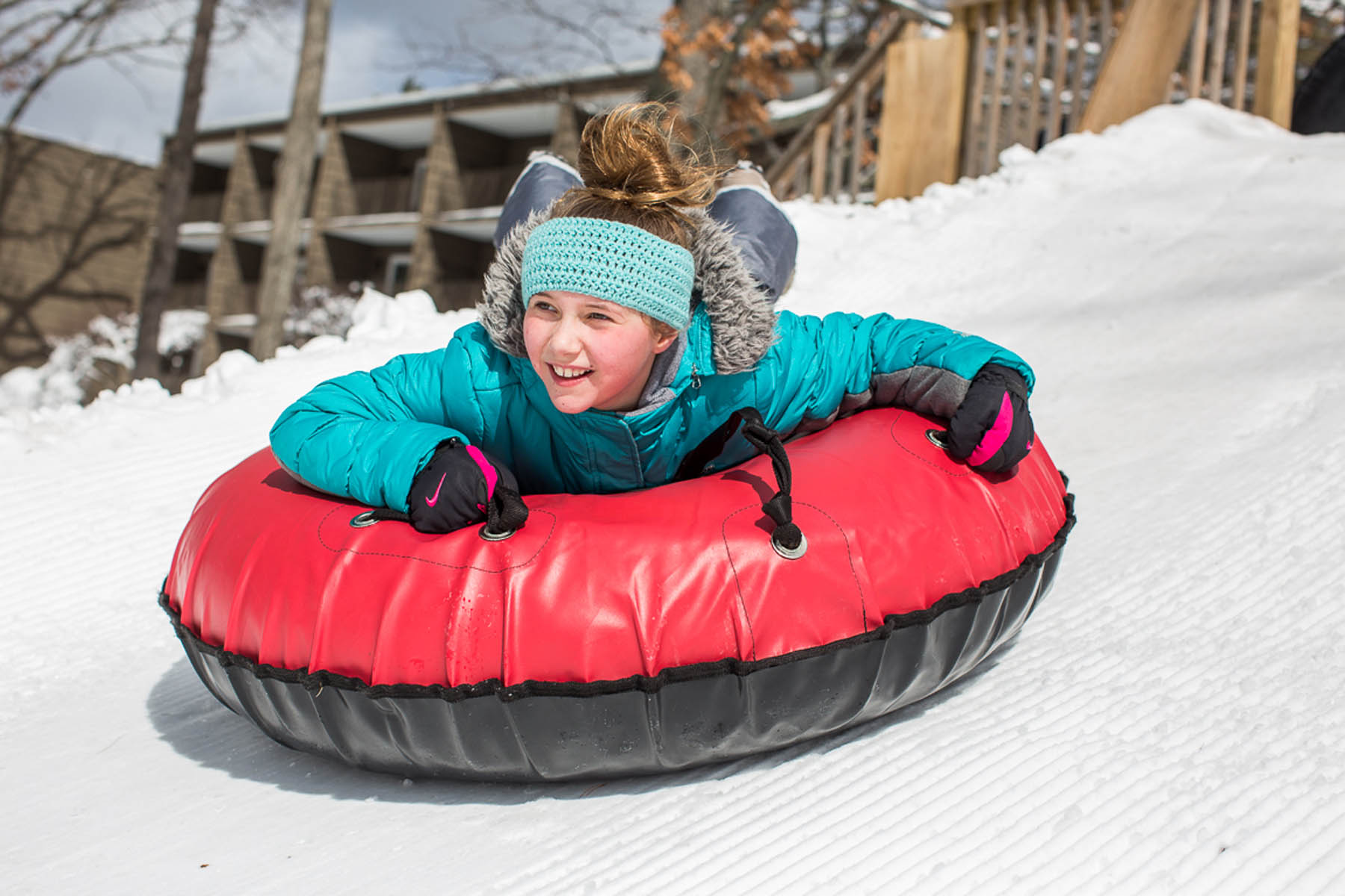 Young girl on snowtube