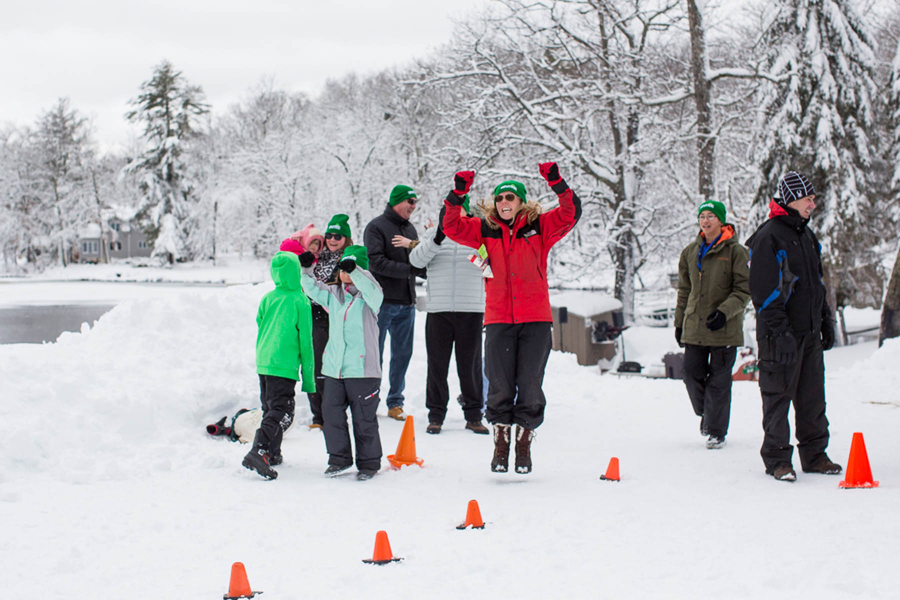 Family cheering outdoors in winter snow.