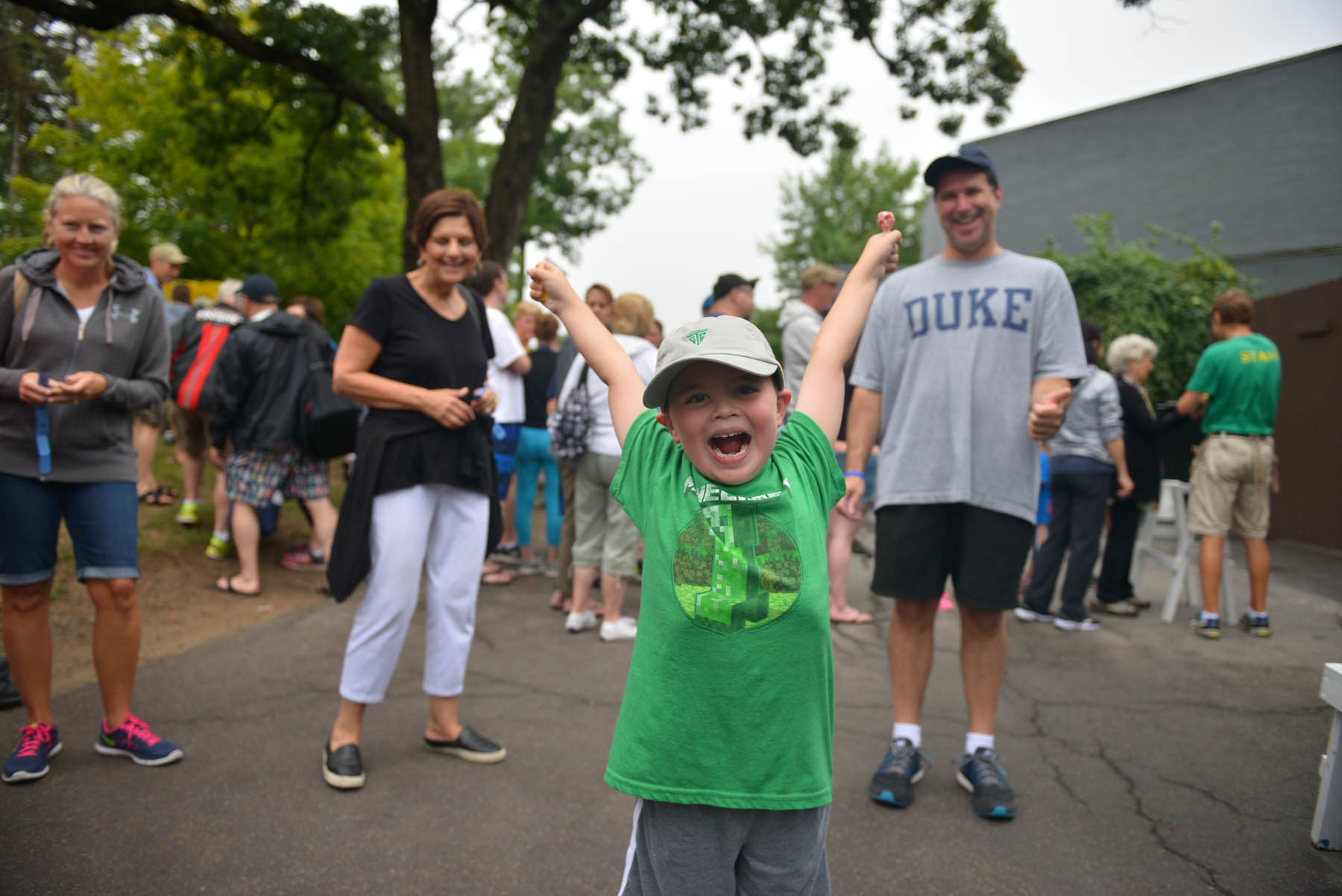 Young boy cheering.