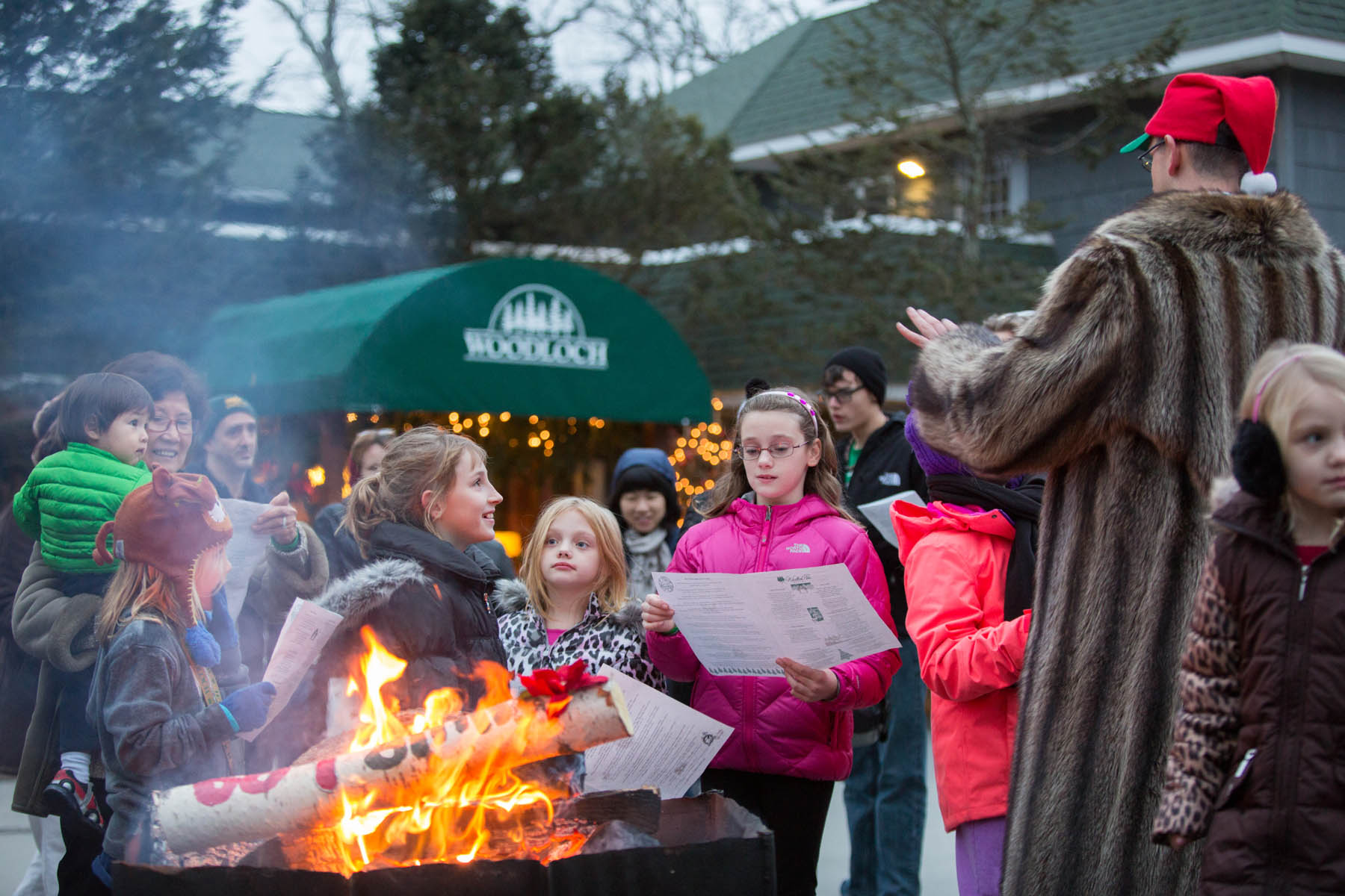 Children singing Christmas Carols outdoors.