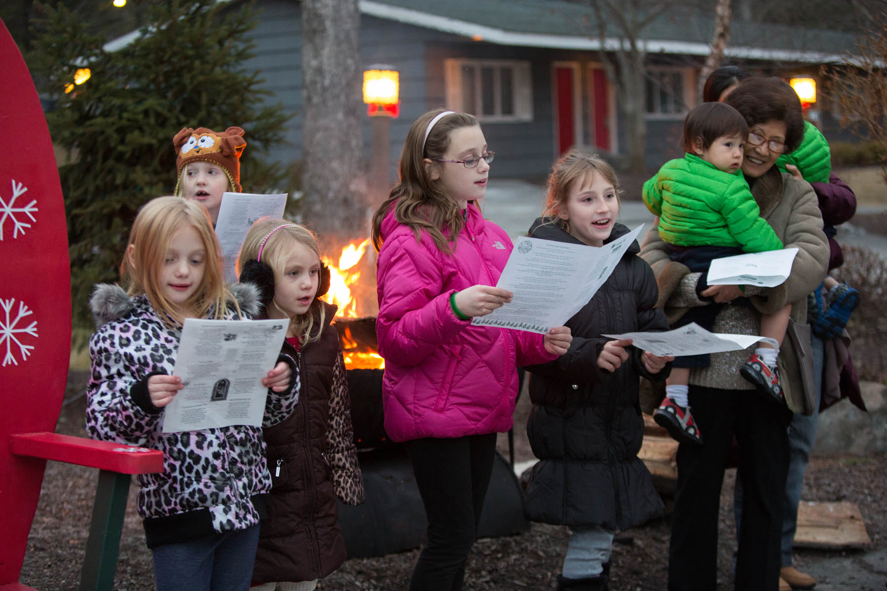 Children outdoors singing Christmas carols.