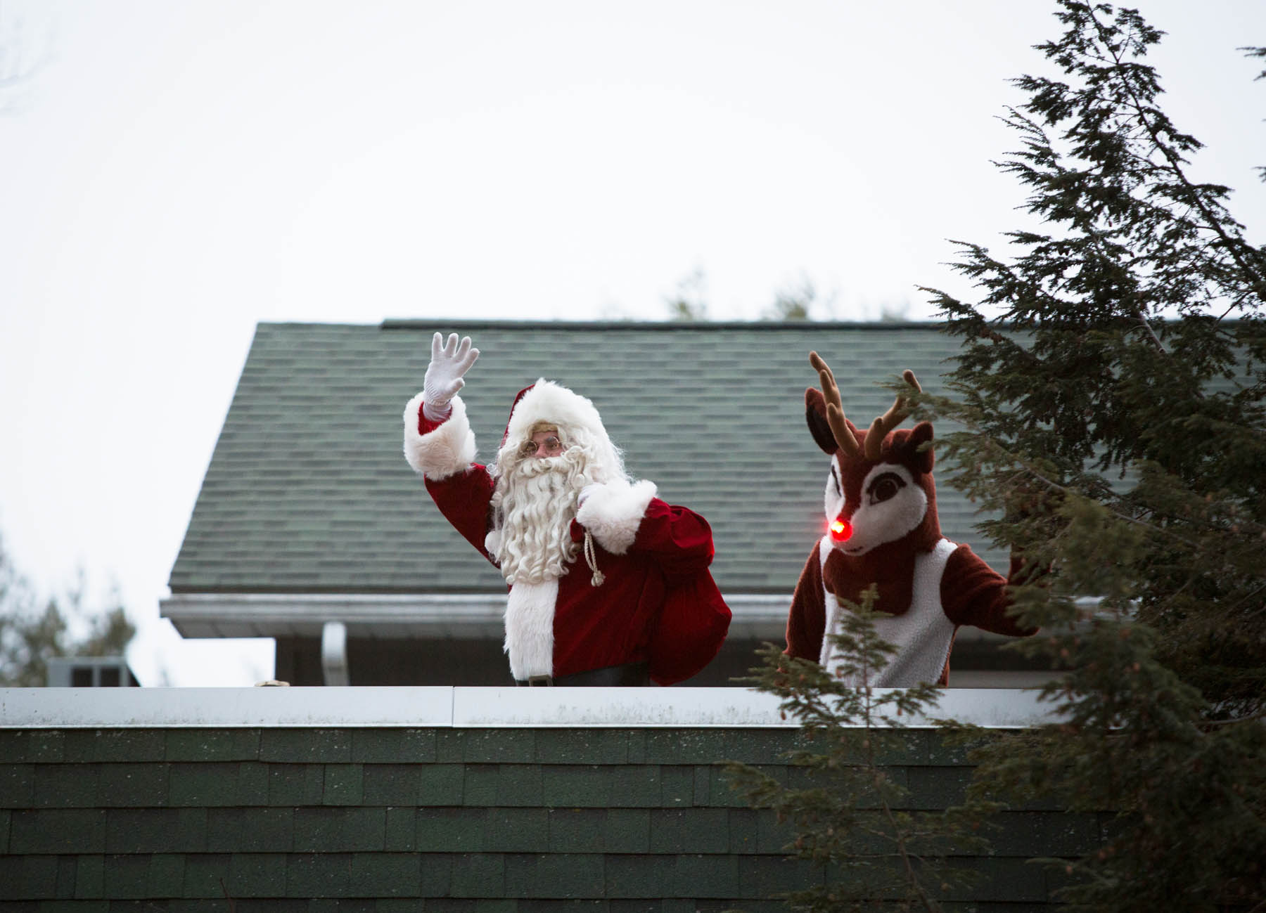 Santa Claus and Rudolph waving.