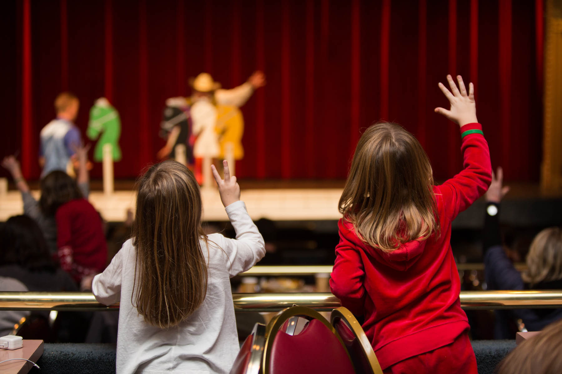 Young girls cheering for horse number two.