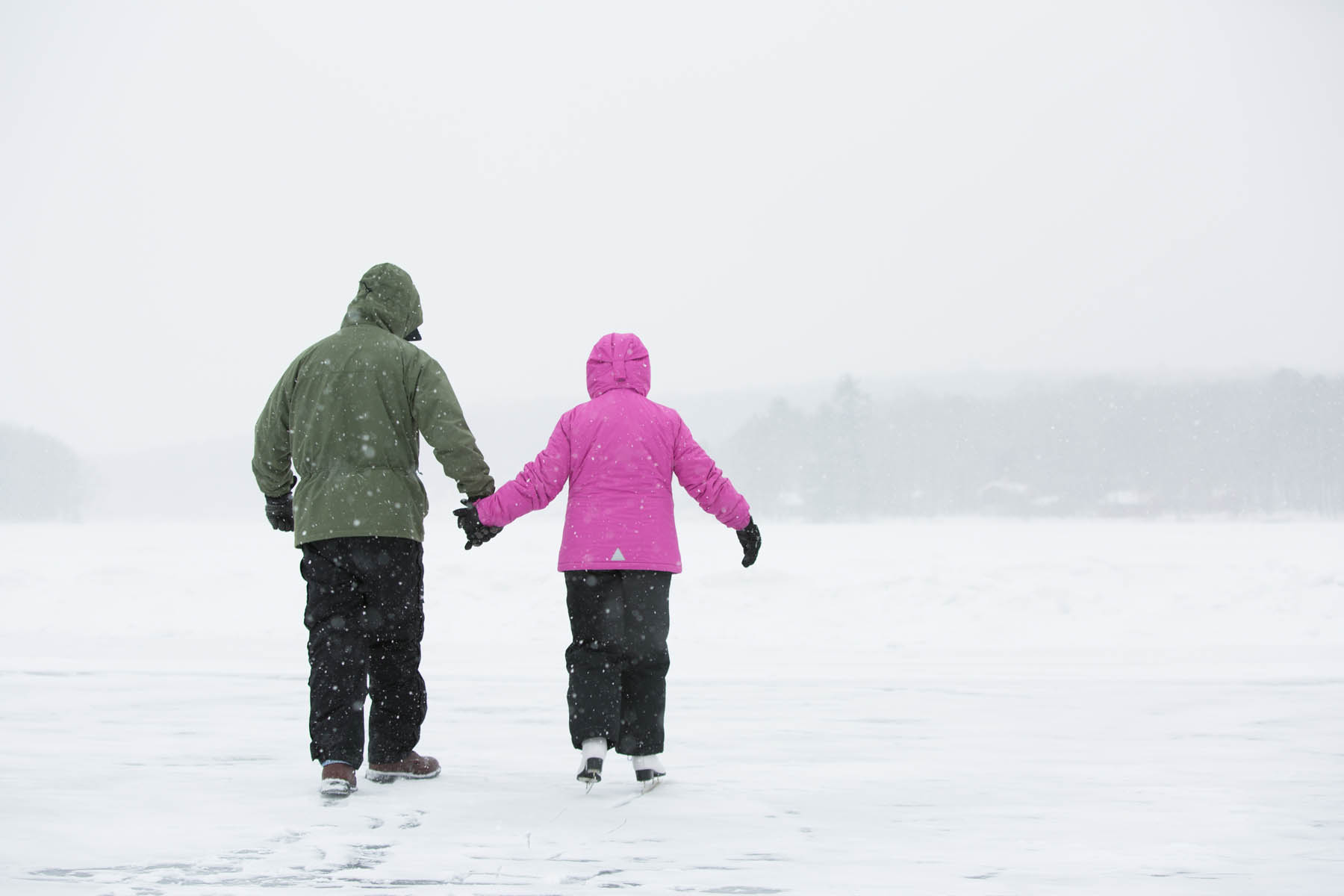 Couple walking in winter snow.