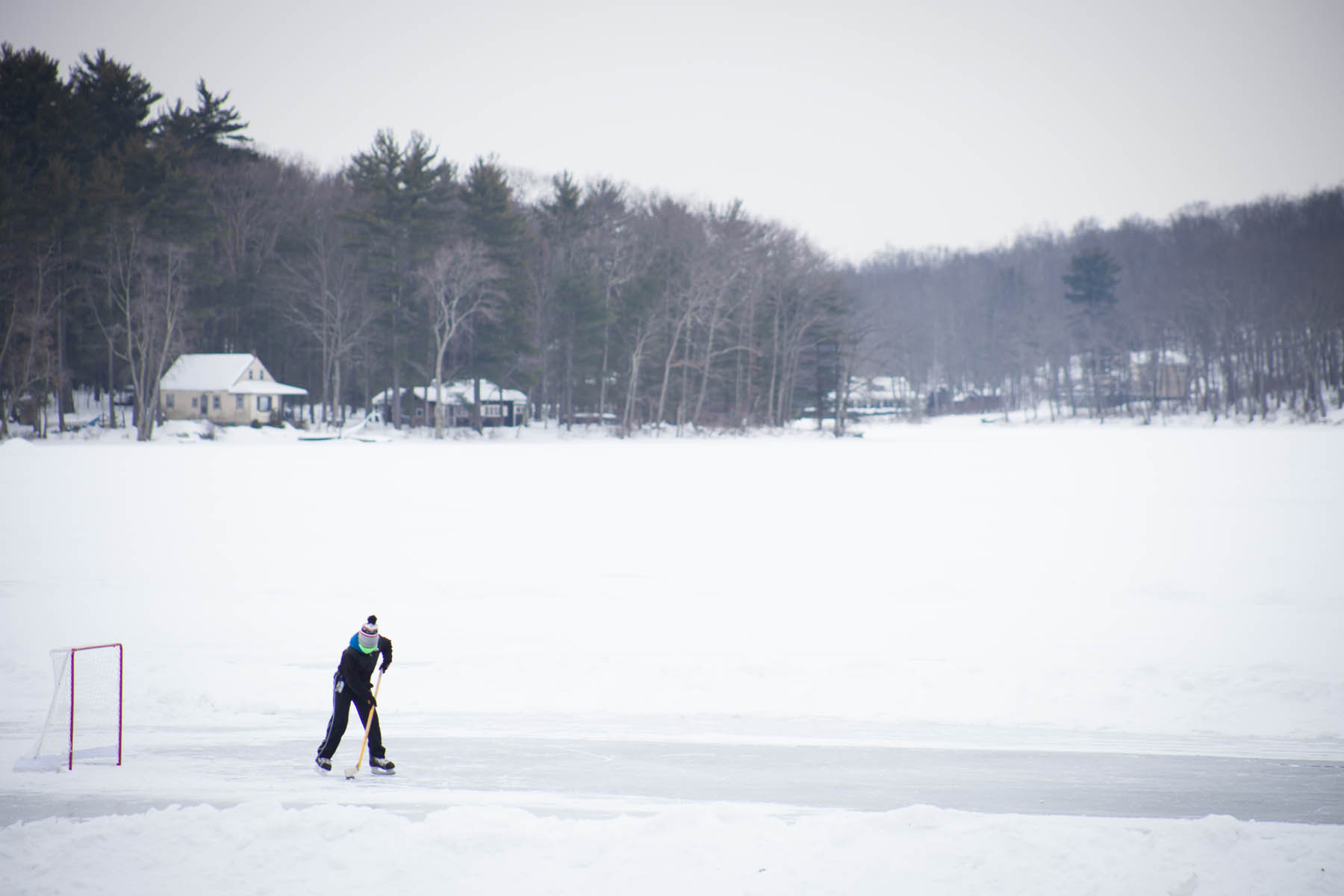 Hockey plater on lake ice in winter.