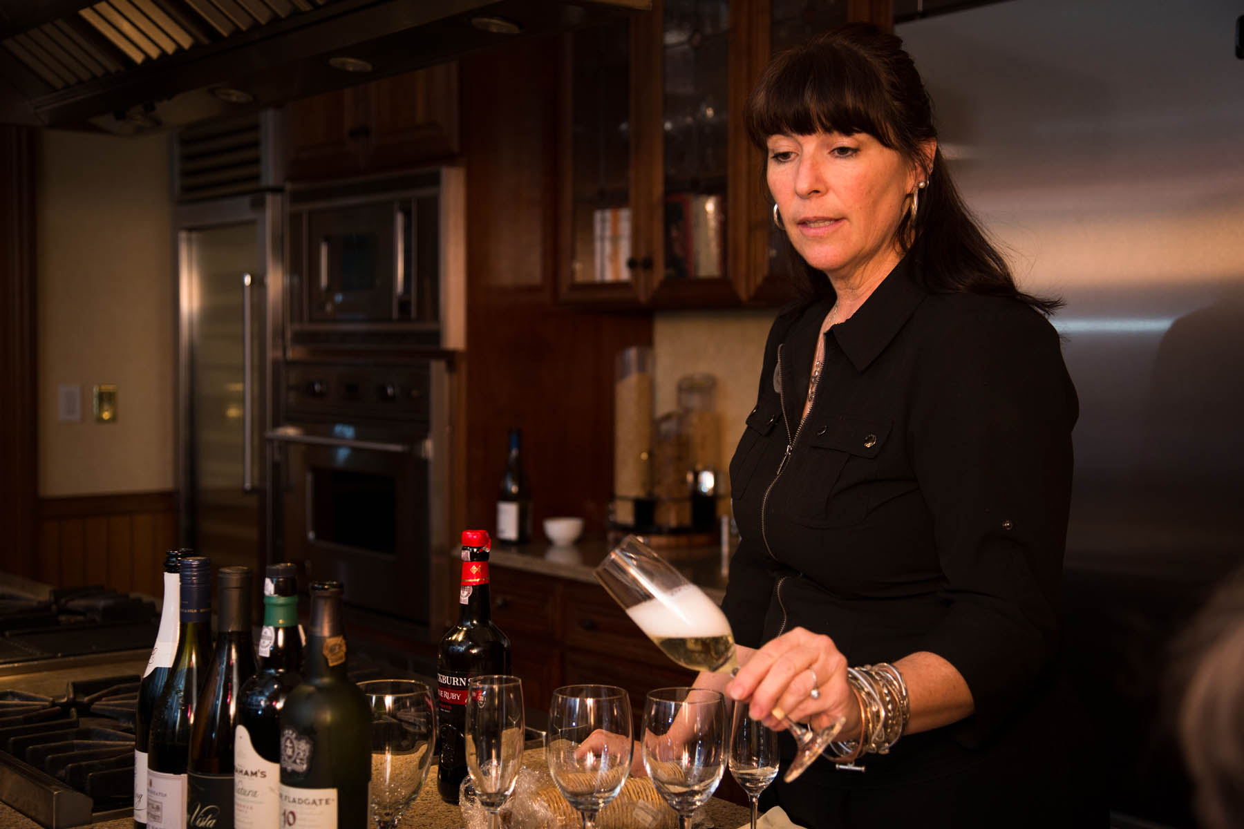 Bartender tipping champagne glass.