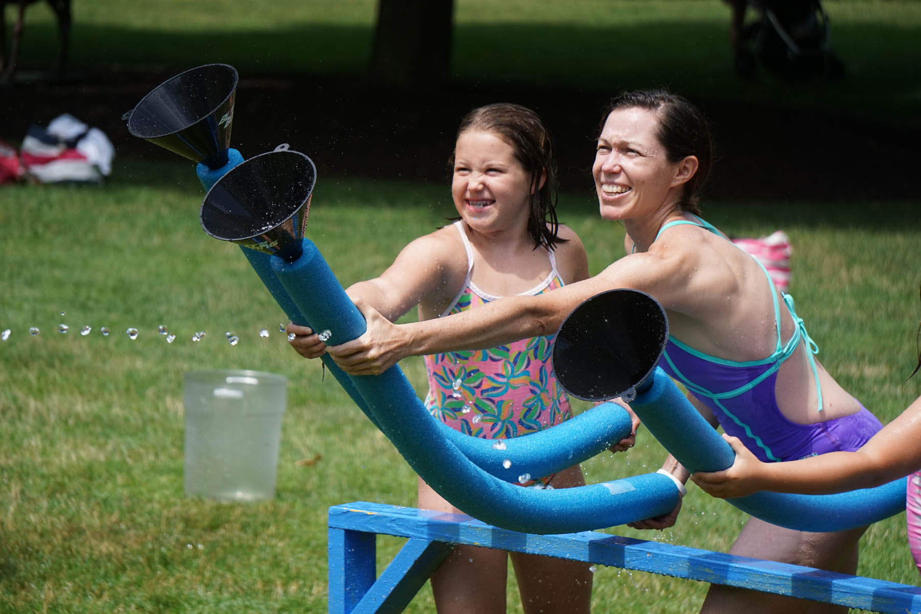 Mother and daughter holding funnels.