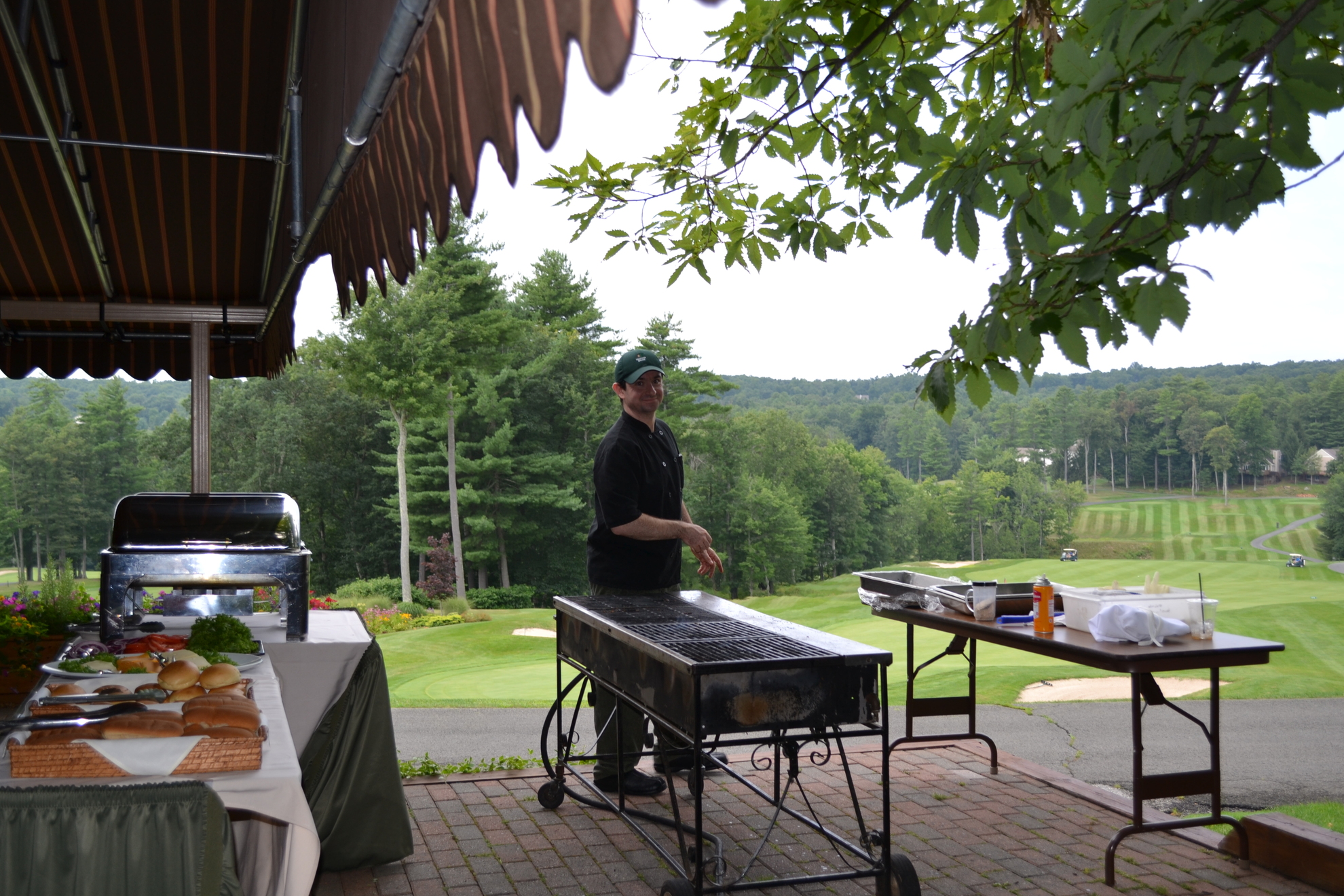 Chef prepping barbeque grill and buffet.