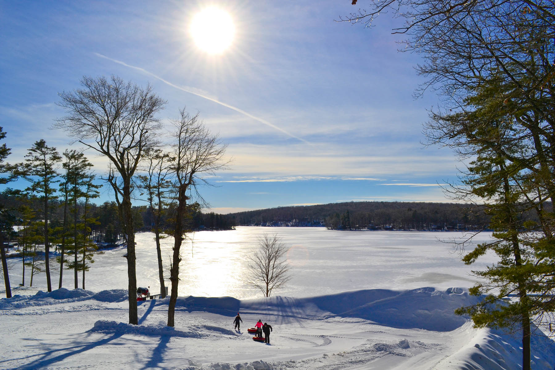 Sunny winter view of sledding hill and Lake Teedyuskung