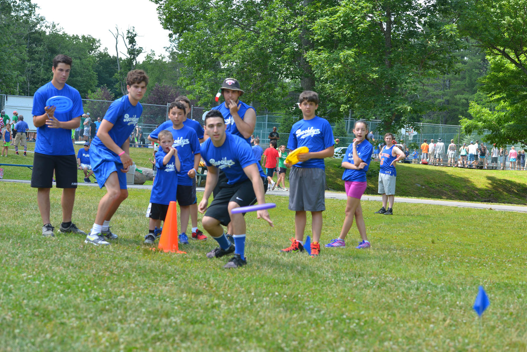 Young people with frisbees.