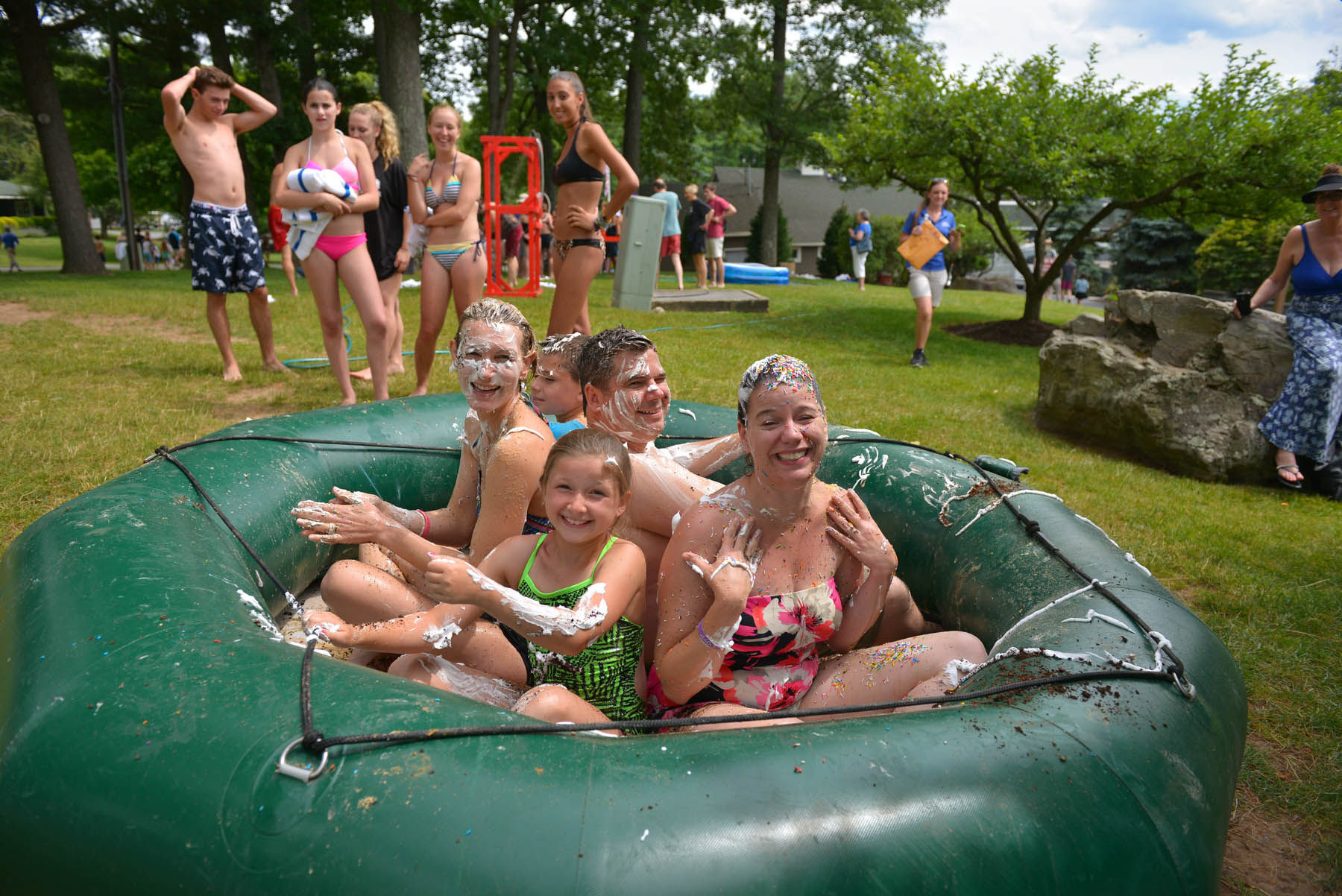 Young people covered in whipped cream/foam.