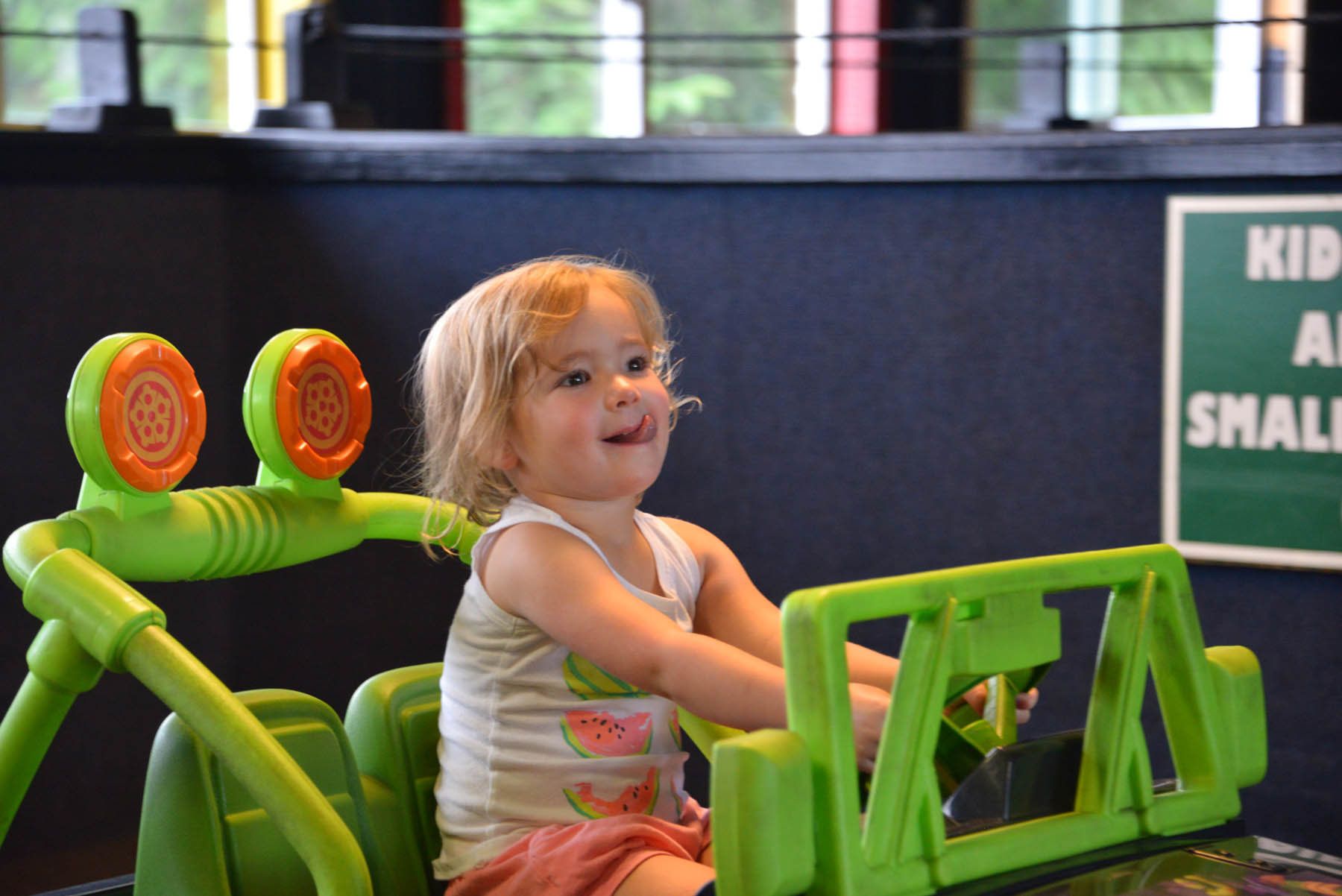 Toddler in a kids bumper car.