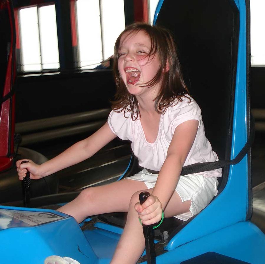 Happy young woman in a bumper car.