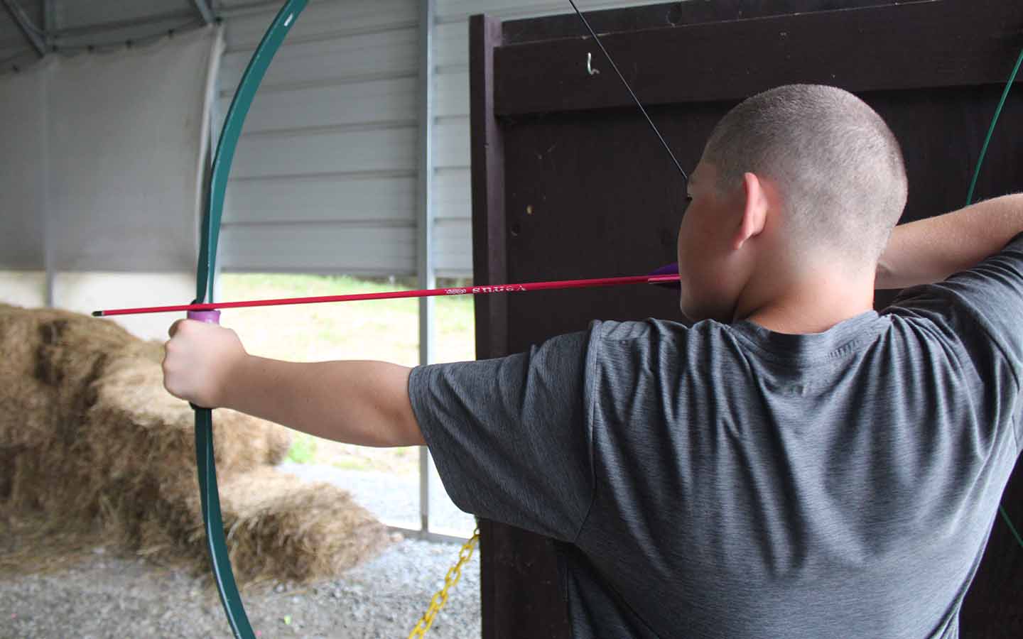 Man aiming a bow and arrow.