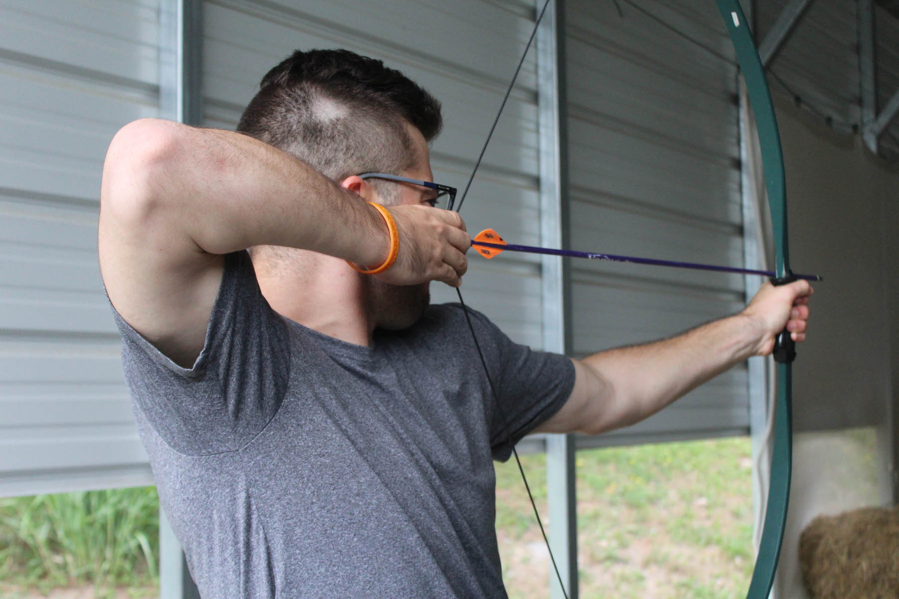 Man aiming a bow and arrow.