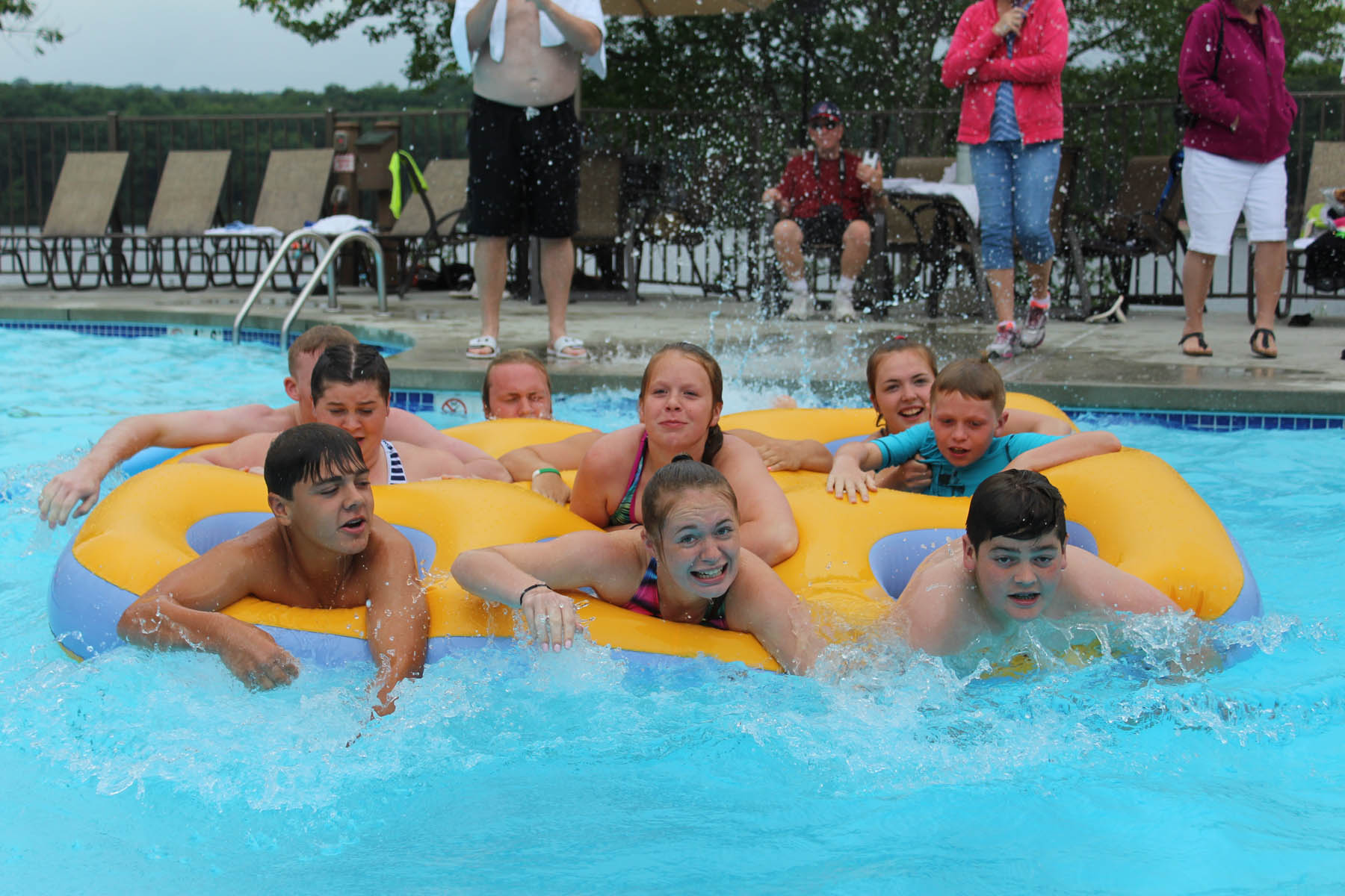 Group of young people in a six person inner tube.