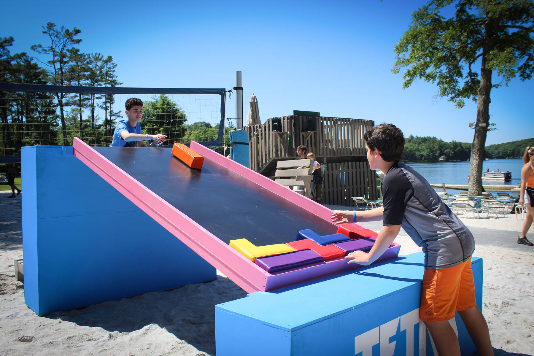 Young men playing Tetris with real blocks.