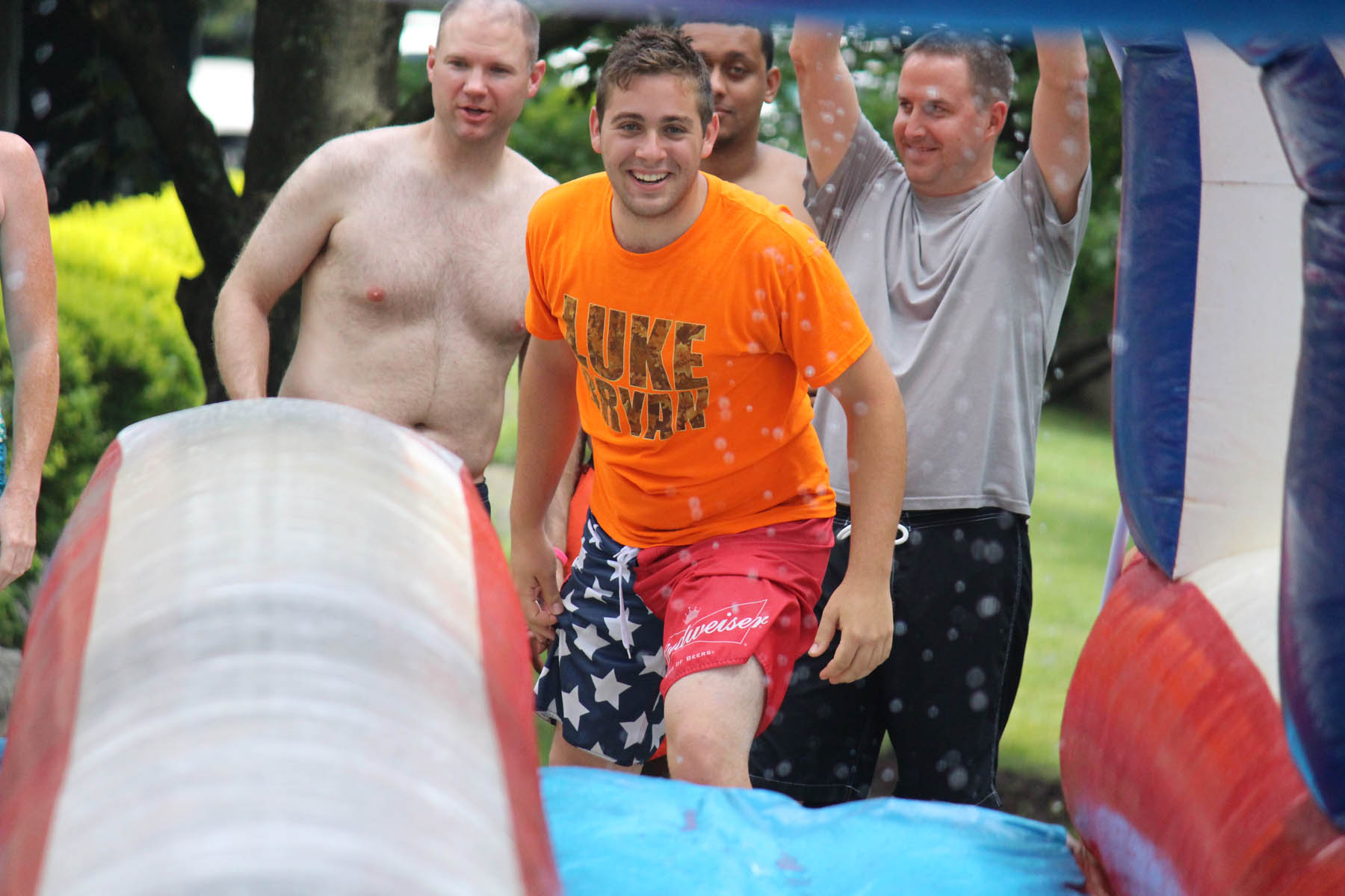 Man preparing to run down a waterslide.