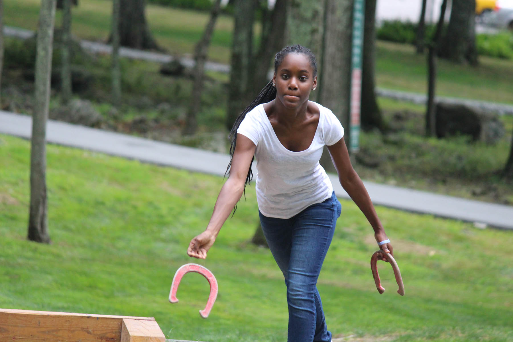 Young woman throwing a horseshoe.