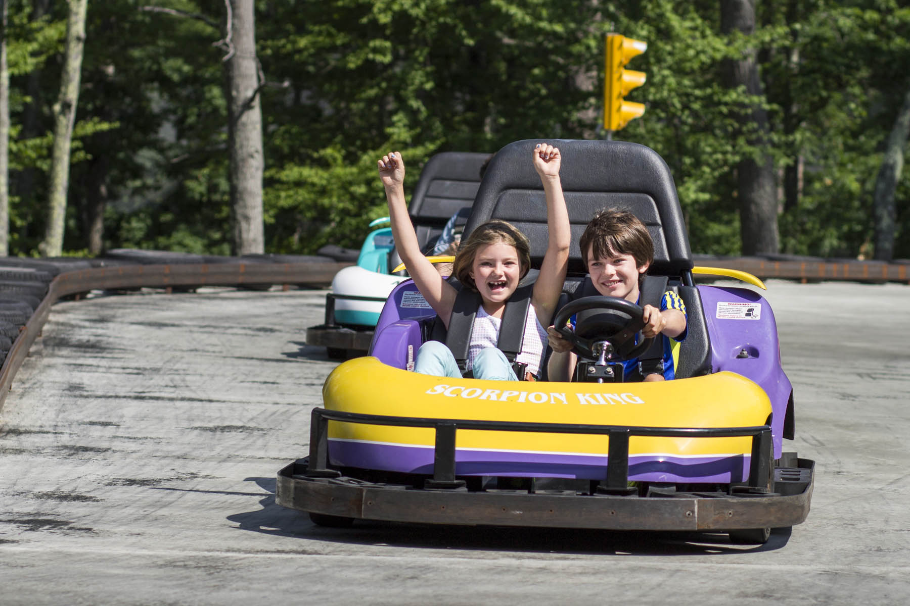 Boy and girl in a gokart.