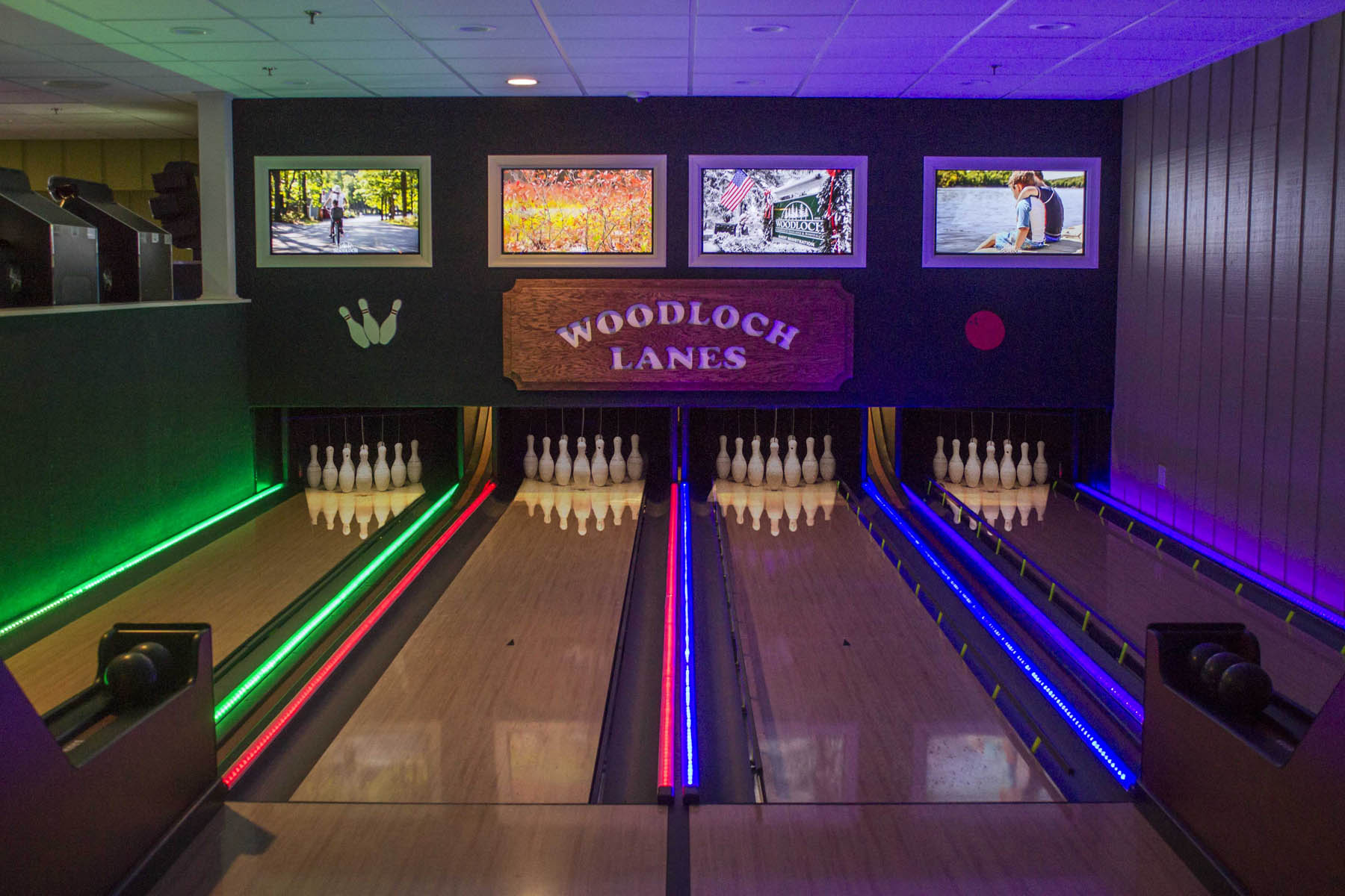 Woodloch bowling lanes with neon lights.