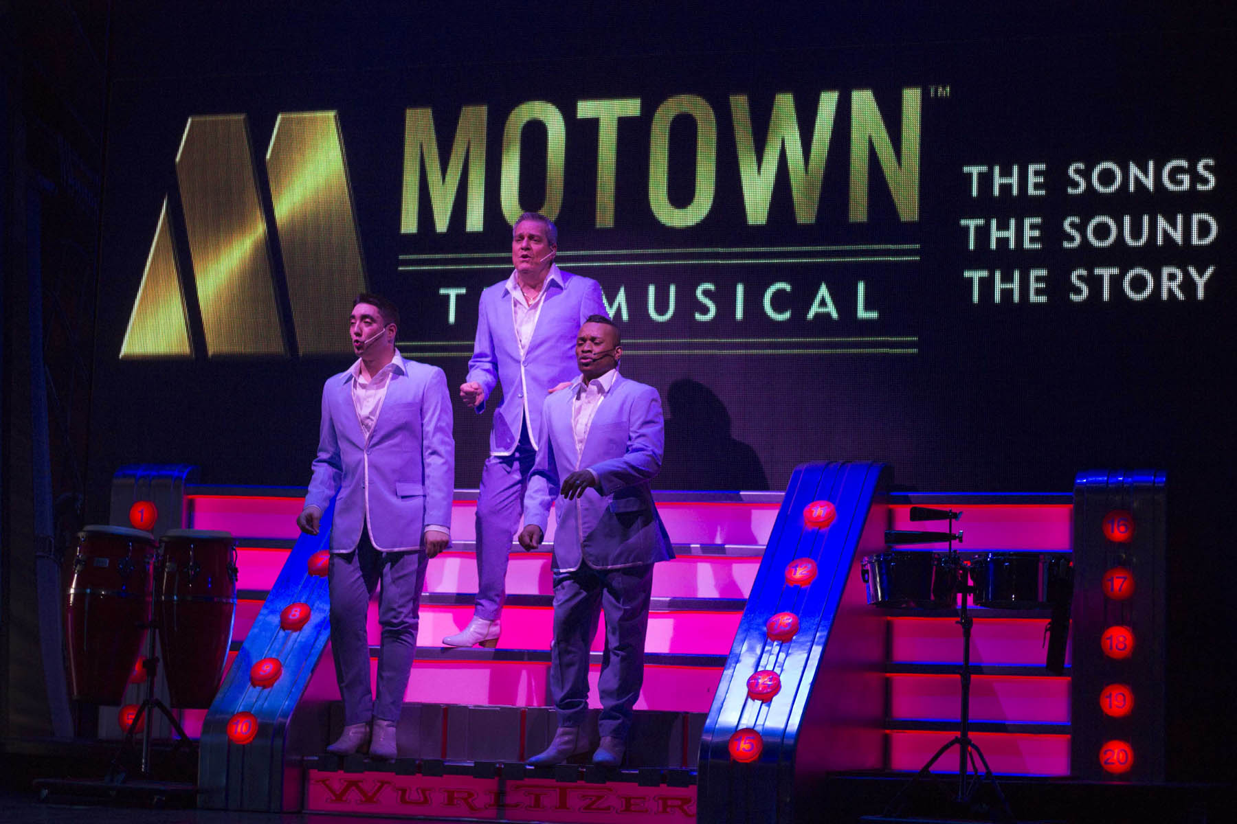 Men singing Motown songs on stage.