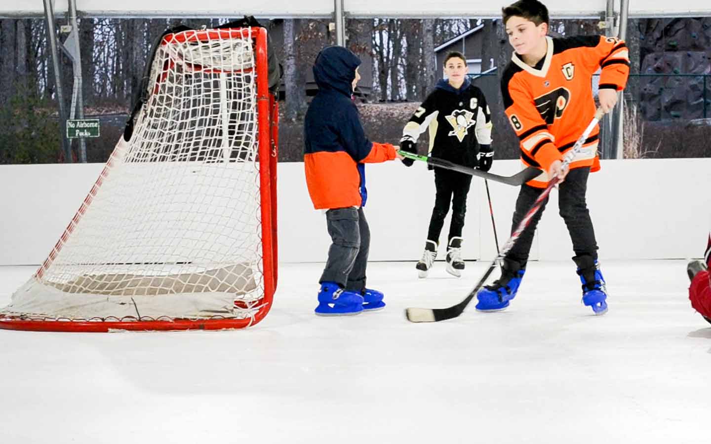 Young men playing hockey outdoors