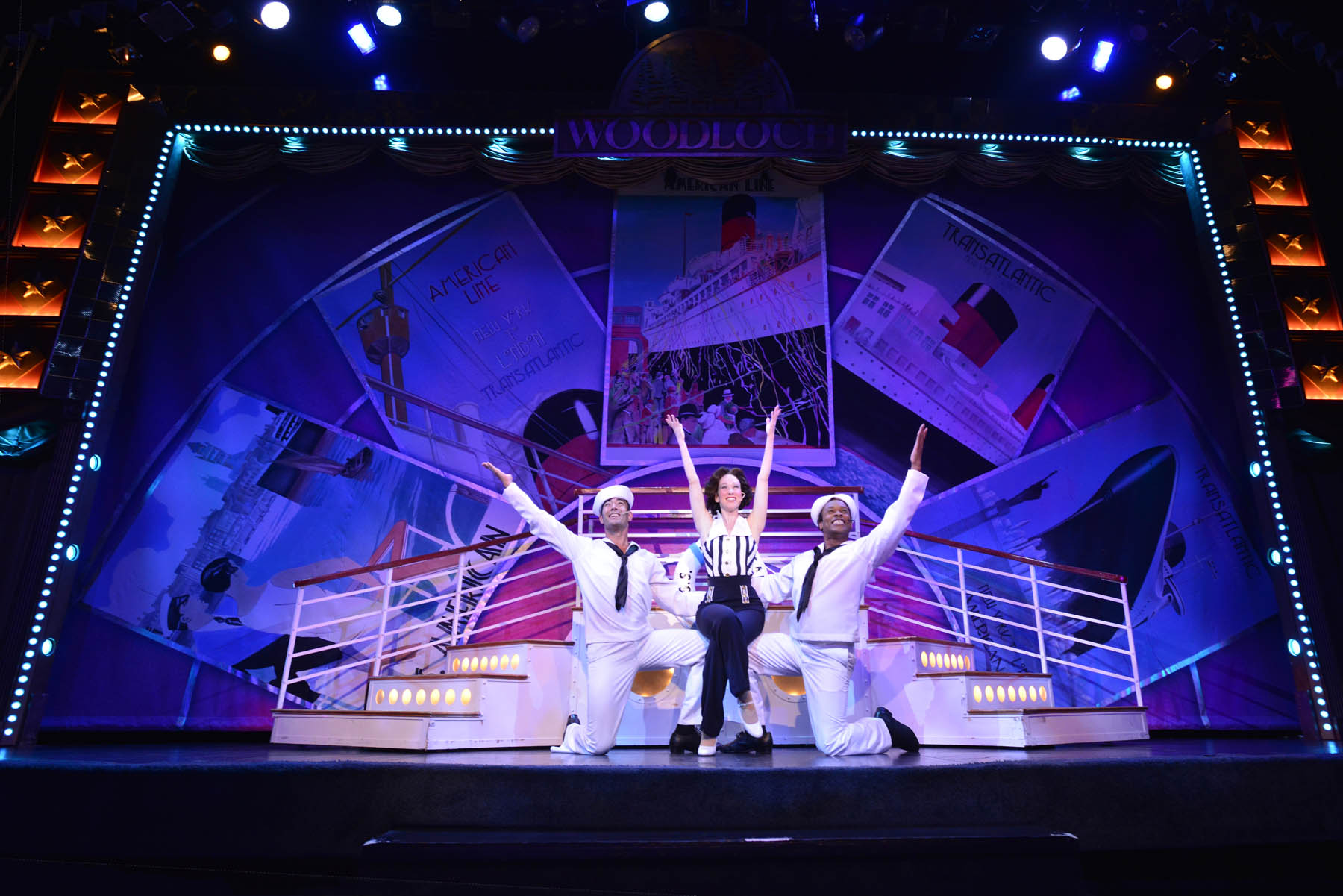 Sailors and woman posing on stage.