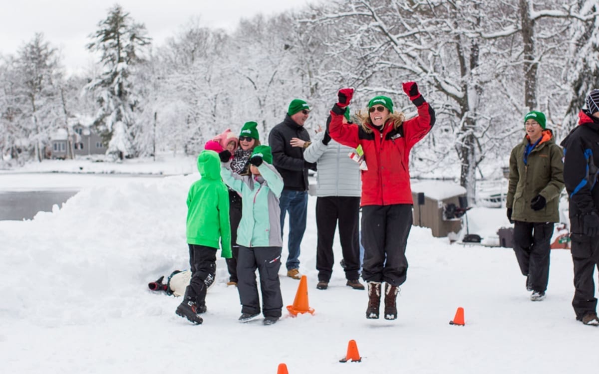 Family cheering outdoors in winter snow.