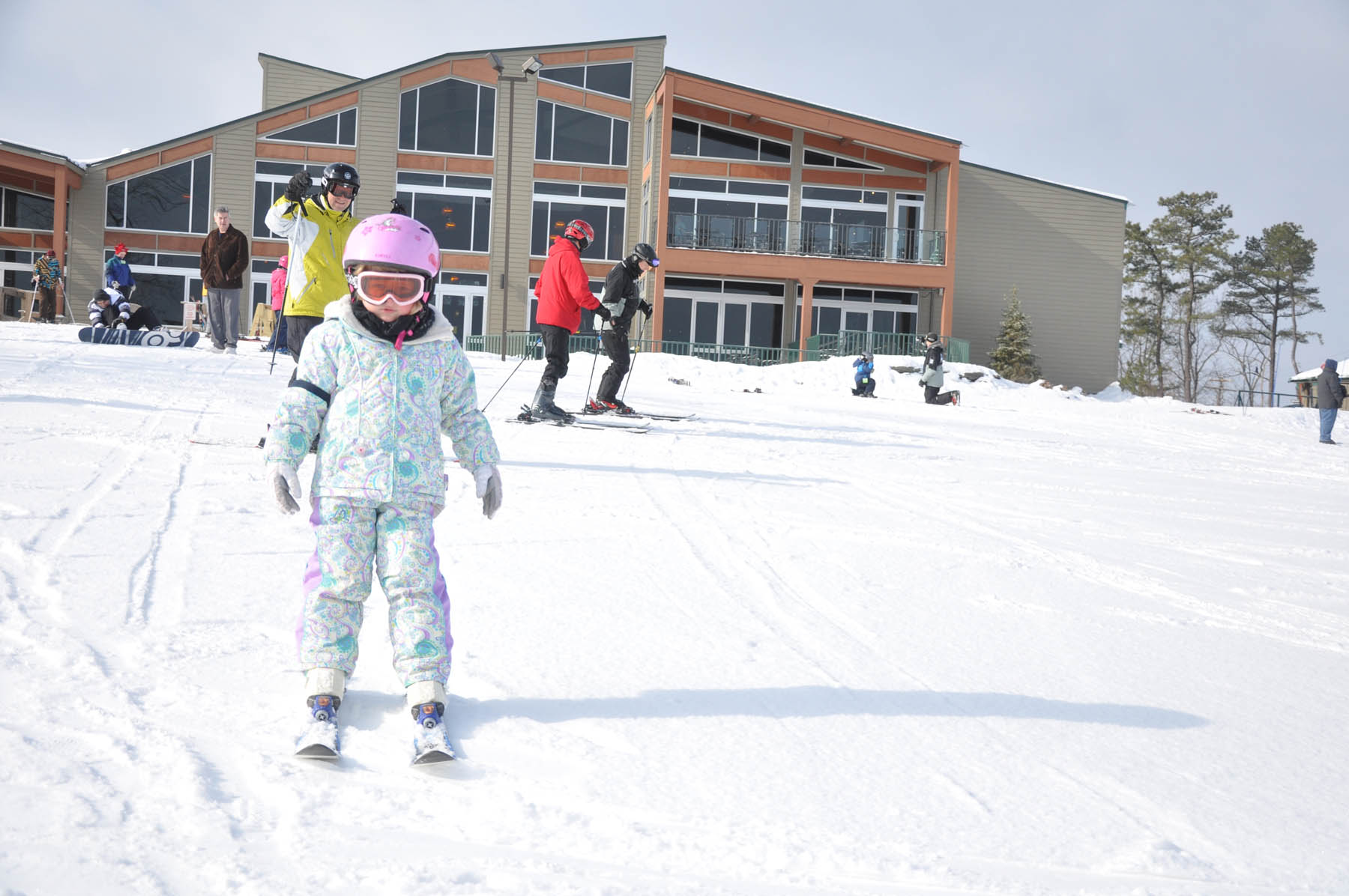 Young girl on a beginner ski hill.